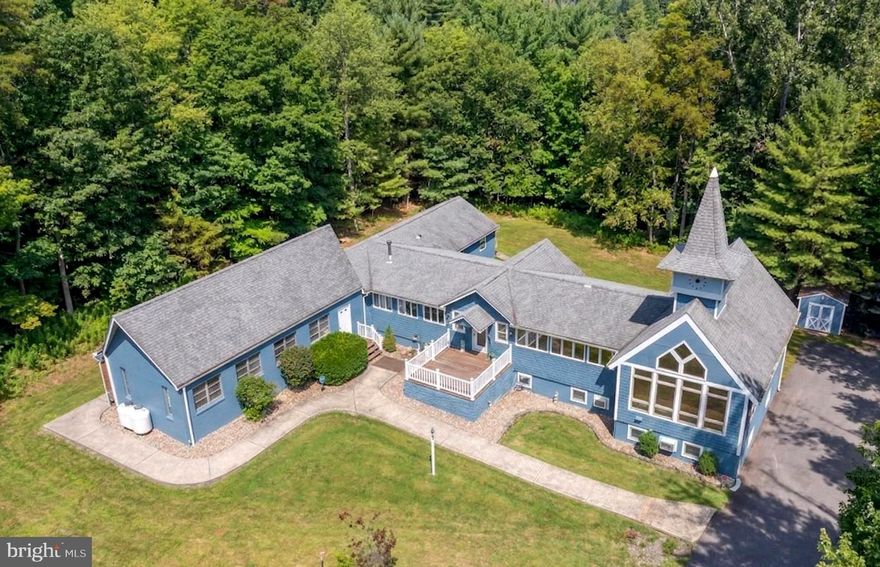 Iconic Lake Access Lodge at Carmel Cove – This one-of-a-kind property at Deep Creek Lake has 10 Primary Suites with an additional 2Bed/2Bath owner’s apartment on the lower level. Privately tucked away on 2 Acres of mature wooded land, you get the secluded feel of a personal mountain retreat with all the comforts of home! Featuring a massive great room with vaulted ceilings, timber accents, and an abundance of natural light. Fully renovated modern kitchen with granite tops, stainless appliances, and butcher block island bar. Breakfast nook on the way to the dining hall with its own stacked stone fireplace, coffee bar, and a wall of glass to let in the surrounding natural beauty. Covered porch off the main living area with private space on the wrap-around deck for each of the main level suites. The peaceful wooded setting for the bonfire pit. The convenient path down to your assigned Dock Slip is right next to the swimming platform in a no-wake cove. A well-established vacation rental, “Carmel Cove” has consistently averaged $100K+ annual rental income (between $100k-$140k over the last four years)! The sky is the limit for any future owner of this phenomenal lake access estate.  Call today for details!