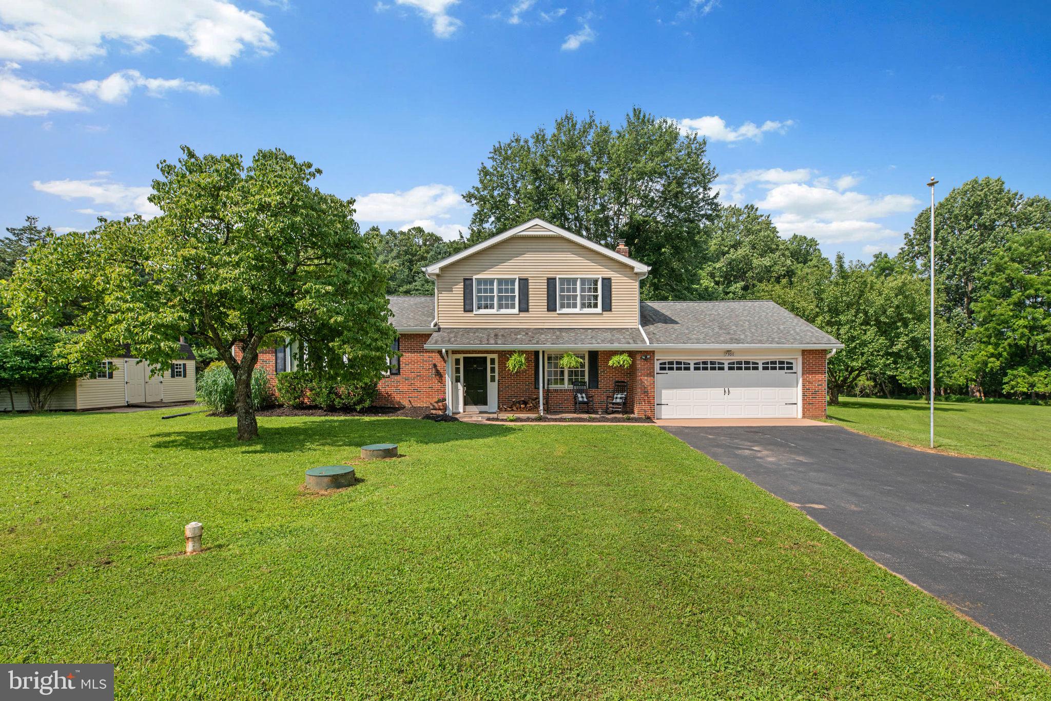 Beautifully maintained and extensively renovated in 2019, this inviting split-level residence offers 2,060 square feet, 3 bedrooms, 2 full bathrooms, and an oversized 2-car garage. Perfectly positioned on a peaceful cul-de-sac in sought-after Marriottsville, the home offers both charm and modern updates in a serene setting. A covered front porch with a stone floor and a built-in brick planter box creates a warm, welcoming entrance.
Inside, luxury vinyl plank flooring (2019) flows seamlessly across the entry and main levels, enhancing the bright, open feel. The foyer features custom coat hooks and opens to a versatile room that can serve as a study or potential fourth bedroom. Just ahead, the cozy family room is anchored by a whitewashed brick adorned wood-burning fireplace, exposed ceiling beams, a built-in shoe storage nook, and a sliding glass door that leads to the screened-in porch. A beautifully updated full bathroom completes this level. Upstairs, the main living area is filled with natural light. A spacious living room with a large bow window and a brick-accented wood stove connects effortlessly to the formal dining room, where an elegant updated chandelier adds a touch of sophistication. The adjacent eat-in kitchen, renovated in 2019, is a true showpiece—featuring stainless steel appliances, white shaker cabinets with soft-close drawers, a glass mosaic tile backsplash, Calacatta Laza quartz countertops, a center island with breakfast seating, and a pantry. On the uppermost level, hardwood floors flow into three generously sized bedrooms, including a serene primary suite with mirrored closets featuring custom shelving. A centrally located full bathroom serves the upper level with ease. The walk-out lower level includes a dedicated storage area and an LG® washer and dryer for added convenience.
Outdoor living is just as inviting. Relax year-round in the large enclosed screened porch with a ceiling fan and stone flooring, or step onto the patio and take in the expansive, level backyard, complete with a storage shed and a tranquil wooded backdrop. This home also offers quick access to Route 70 and is conveniently located near shopping, dining, and amenities in Howard County, Eldersburg, and Ellicott City.
PLEASE REVIEW FEATURES LIST FOR DETAILS ABOUT THIS AMAZING HOME!