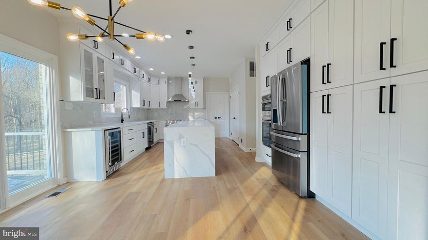 An exceptional and truly stunning 3-level Colonial residence, exquisitely renovated and offering 6 bedrooms, 4.5 baths on 2.41 private acres in a serene cul-de-sac setting. Surrounded by woods on three sides and featuring a vast, flat backyard backing to nature, this remarkable home offers rare privacy and breathtaking scenic views—while remaining conveniently close to shopping, dining, entertainment, and major highways.

The main level showcases a newly redesigned gourmet kitchen appointed with premium stainless steel appliances, including a wall oven and microwave combo, refrigerator, stove, designer range hood, dishwasher, and wine cooler. Quartz countertops, upscale custom cabinetry, and a dramatic waterfall center island complete the space. The kitchen opens seamlessly to a sun-filled breakfast area and a spacious family room anchored by a fireplace. Expansive French glass doors lead to a large elevated deck overlooking the meadow and wooded backdrop—an extraordinary setting for relaxing or entertaining.

A formal living room and dining room flow effortlessly together, creating elegant gathering spaces. A private main-level office/library provides the ideal work-from-home environment, and a stylish powder room adds everyday convenience.

Upstairs, the luxurious primary suite serves as a true retreat, featuring three closets and a spa-inspired bath completely renovated with designer finishes. Highlights include new tile throughout, dual vanities with new faucets, mirrors, and lighting, a frameless glass-enclosed shower, and a freestanding soaking tub positioned beneath a sunlit window. A private water closet with its own door and window enhances both privacy and comfort.

A secondary bedroom suite offers a walk-in closet and a fully renovated private bath with new tile, vanity, fixtures, mirror, lighting, toilet, and bathtub. Two additional generously sized bedrooms share a beautifully updated Jack-and-Jill bath, also fully renovated with high-end finishes.

The fully finished walk-out lower level expands the living space dramatically, featuring two additional bedrooms and two brand-new full baths—one with a bathtub and one with a shower. A massive recreation room offers flexibility for multiple functional areas such as a media room, fitness space, or playroom. A wet bar—complete with an additional wine cooler—enhances entertaining, and doors open directly to the patio and expansive backyard.

Extensive upgrades include: New flooring throughout; Fresh interior paint; New designer light fixtures; New high-end synthetic cedar roof; New windows; New garage doors.

Set on 2.41 acres with three sides backing to woods, this property offers a rare combination of refined design, modern upgrades, and exceptional privacy—making it one of the most impressive homes in its price range.

A truly special offering—this is the dream home you’ve been waiting for.