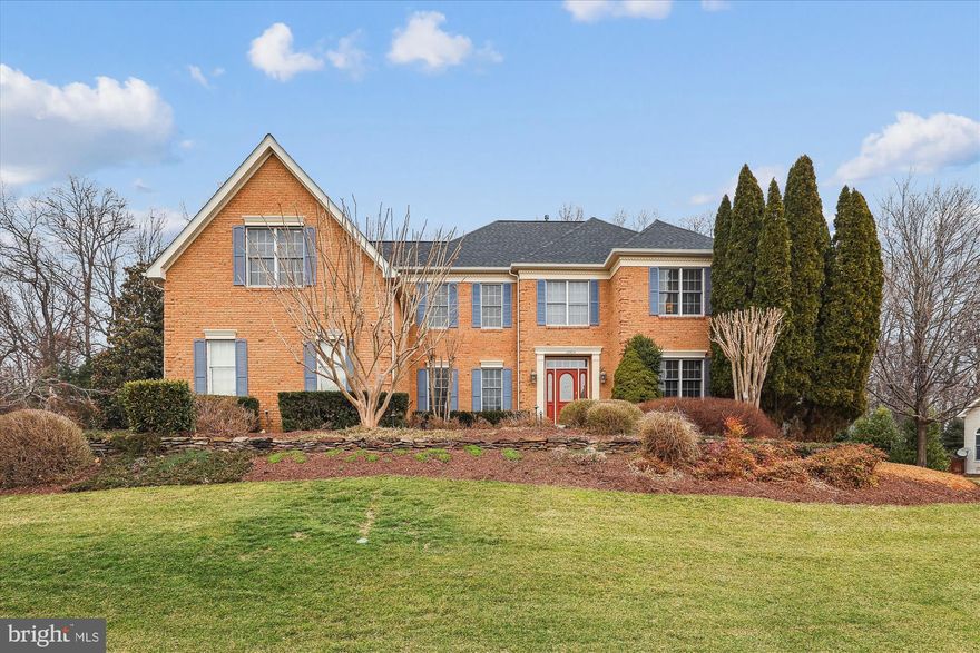 Welcome to this immaculate home, lovingly updated and maintained by the original owners in the fantastic neighborhood of Great Falls Crossing. 10904 Hunter Gate Way has been beautifully upgraded inside and out with great attention to detail. This 4 bedroom, 4.5 bath home offers over 5000 SF and is nestled on a very magical, near-acre, landscaped lot. This double lot commanded a $50,000 premium when purchased in 1999. A custom slate walk way, a pretty as a picture pergola, and a 3-car side load garage invite you in to a spectacular open floor plan with a grand two story foyer, dual staircases, and a catwalk overlooking the family room. The formal living room and dining room feature extensive molding and designer touches with an accent fireplace and elegant wallpaper. The gourmet eat-in kitchen showcases white cabinetry with stainless steel Kitchen Aid appliances, a leathered granite island with seating, gorgeous backsplash, pendant lighting and cabinet lighting, plus a large pantry with pull-outs. A spacious breakfast room leads into the family room with soaring ceilings, built-in cabinetry, a gas fireplace and sky lights. The beautiful sunroom with a wall of windows has vaulted ceilings, sky lights and a sliding glass door to an AWESOME screened-in porch, large enough for two sitting areas, with ceiling fans, an outdoor TV, and impressive wood ceilings. This is outdoor living at its finest with a slate patio running the expanse of the backyard, a built-in gas grill, a firepit, a retractable awning and mature landscaping. The mud room is beautifully finished with charming wainscotting and LVP floors offering additional cabinetry and access to the screened in porch. A spacious office with a wall of custom built-ins and an updated powder room complete the main level.
The enormous primary suite was reconfigured to offer not two walk-in closets but THREE. There is closet space galore with two additional sitting areas that are perfect for a dressing room, an office, workout room, or media room. The luxury primary bath has been renovated with a claw tub, dual vanities and oversized glass doored shower. The other 3 bedrooms are all spacious with ample closet space, one includes a renovated ensuite bath while the other two share the renovated hall bath. All beautifully done. 
The lower level is a real treat with a large Clyde’s-like bar that can easily sit 6 with custom cabinetry and the conveniences of a refrigerator, dishwasher, ice maker and television. The pool table conveys and there is still room for a large recreation area. Through a glass door, you will find a proper poker room/game room with custom shelving and a secret white board for more family gaming fun. This room is equipped with a restaurant style air filter system for those who appreciate the celebratory cigar. The walk-up stairs are located here which would accommodate converting this into a legal 5th bedroom if so desired. Built-in speakers run through the main and lower levels. The storage room includes walls of shelving and runs the expanse of half the house, it is huge. Brand new roof in 2024, Dual Zone HVAC 2023 and 2015, HWH 2024.
But let’s not forget the 3-car side load garage! There are epoxy floors, a gladiator wall system, cabinets, benches, even well-thought-out ball-racks.
This home is conveniently located within a couple of miles to the Metro Station, Reston Town Center, and major commuting routes. The Great Falls Crossing neighborhood offers incredible amenities to include an outdoor pool, tot lot, basketball courts, and tennis courts. There are walking paths to connect to the 55 miles of Reston trails as well as Lake Fairfax Park and the Watermine. This is a truly beautiful home in a fabulous location.