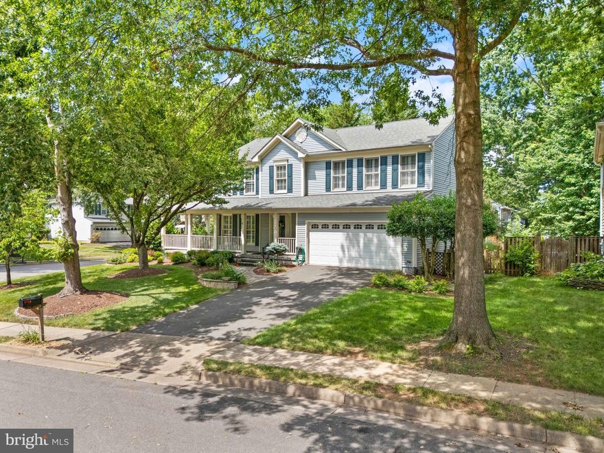 ****Catered Open Houses this weekend on Friday, August 1st from 5-7PM and Saturday, August 2nd from 2-4PM.****
There’s something magnetic about a house that gets it right—something in the symmetry of the porch columns, the rhythm of the shutters, and the quiet way it sits, confident and timeless. This Colonial in Leesburg’s beloved Exeter community isn’t trying to stand out. It simply does.

From the street, it’s the wide front porch that grabs you first. Morning coffee here feels like a ritual worth keeping, and on summer evenings, there’s room for actual conversations—not just a wave—from the rocking chairs. This is the kind of porch that makes neighbors linger.

And then there’s the bonus space you didn’t know you needed but won’t want to live without: a large, all-weather screened porch that feels like an extra living room—minus the bugs. Whether you’re hosting a casual dinner or sinking into a book with a glass of wine, it’s the kind of upgrade that quickly becomes essential.

Step inside and the sense of space is immediate. With over 3,100 finished square feet, including a finished lower level, this home knows how to stretch out. The main level is designed for flow, with a granite-topped kitchen that opens into the dining area and continues into a bright, welcoming living room. Everything is freshly painted, making the whole space feel crisp and move-in ready.

Upstairs, the primary bedroom offers just the right amount of retreat, with a private en-suite bath and windows that catch the morning light. Three additional bedrooms and a full hall bath give everyone room to breathe, spread out, and relax. On the lower level, a fifth bedroom or den gives you even more flexibility—ideal for overnight guests, a home office, or your next Netflix binge setup.

Outside, the yard is beautifully landscaped and thoughtfully designed—not just pretty, but genuinely useful. There’s space to entertain, garden, and play, and enough privacy to feel like your own quiet pocket of the world.

This home isn’t just cared for—it’s being continuously improved. A brand-new roof and all-new siding are on the way, bringing peace of mind (and curb appeal) for years to come.

And then there’s the location. Not “close to” Leesburg—in Leesburg. Downtown’s shops and dining are just minutes away. Across the street, the Ida Lee Rec Center and AV Symington Aquatic Center offer indoor gyms, classes, and a full water park. Want to feel plugged into the community? All of Leesburg’s iconic parades begin right outside the Exeter neighborhood. It’s the kind of place where you don’t just watch the charm—you live inside it.

And when you want to roam farther, the HOA amenities keep it all easy: community pool, tennis courts, tot lots, trails for biking or jogging. Everything’s here, but nothing’s overbearing.

Some homes check boxes. This one invites you to stay awhile—and imagine what comes next.