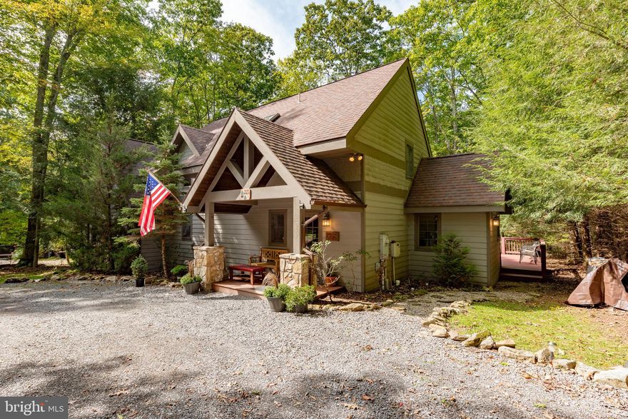 Tucked among the trees, Blue Spruce offers a perfect blend of modern comfort and serene natural beauty. This recently remodeled 4-bedroom, 4 and a half bathroom home invites you to relax, recharge, and reconnect with nature. With each bedroom offering an ensuite bathroom plus a half bath near the kitchen, this home was designed for comfort. Step inside to discover thoughtful updates throughout, including fresh paint in every room and beautifully renovated bathrooms. Charming details add character and warmth, while the spacious great room—with its cozy fireplace and large windows—provides the ideal gathering space for family and friends. Outside, enjoy your morning coffee on the expansive back deck, unwind in the hot tub, or head down to your exclusive Type A dock for a day on the water. Whether you're watching movies indoors or stargazing outdoors, Blue Spruce delivers comfort and connection in every season. Perfectly located in the heart of Deep Creek Lake, you’ll be minutes from local shops, restaurants, skiing, hiking, and all the recreational activities the area has to offer.  Whether you’re seeking a private escape, a family vacation home, or a smart rental investment, Blue Spruce is your idyllic lakeside retreat.