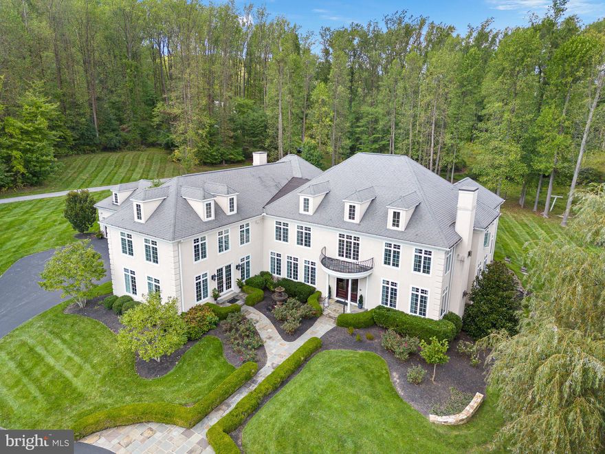 Estate-like serenity awaits in 211 Pumpkin Hill Road. This 6 bedroom 8.5 bath home boasts over 12,600 sq ft of living space. You enter the home through the grand foyer, flanked with a spacious dining room that holds seating for a dozen guests, opulent chandelier pairs, floor to ceiling windows, and rich hardwoods, as well as a large sitting room/living room off to your right. The foyer walks you to the rear of the home where guest quarters are found with a private ensuite and walk-in closet. To the interior of the home you will find the custom kitchen with floor to ceiling cabinetry that is paired in an on trend two-tone color scheme with the large center island(s). The countertops are a neutral colored grain granite that really anchors the space. From the double wall oven to the commercial grade range, no detail has been spared in this chef's dream of a space. A wet bar and wine refrigerator, as well as a breakfast nook, which is currently set for seating for twelve, round out the space. Off of the kitchen you will find the primary family room. This area of the home is inviting and bathed in natural light, while still holding those elevated touches such as the coffered ceilings. From the family room you will enter a hall that holds another bath, and then onto a large private office with separate  entrance and walkway from the outside.   This executive size office, plus two staff space is ideal for remote workers.

The second level of the home can be accessed by multiple stairways, creating split floor plan access and privacy between the four bedrooms and primary. Let us visit the floorplan from the hall adjacent to the sunroom and office, where you will enter the second level into a beautiful loft/sitting area. All four of the bedrooms in this wing of the home hold ample square footage and closet space, along with their own private ensuites. The convenience of a second floor laundry is also found in this section of the home. through a hallway, flanked by two story access to the lower level, you will find the primary suite. Truly an apartment-like feel in space, this suite holds the owner's bedroom, sprawling seating area, walk-in closet, and private ensuite with soaking tub, stand alone shower, and custom double vanity space. 

The home holds an entertainer's paradise, as the lower level is a home in itself. With a full secondary kitchen, billiards room, rec room, family room, office, workshop, sauna, full bath, and steam room, you are left with endless amenities and accommodation in this level of the home. 

The expanse of this property brings us to its exterior features. Indoor and outdoor living at its pinnacle, a large stone patio holding two dining spaces walks down to the pool area. Complete with lush landscaping for privacy, this fenced-in area of the yard leads onto the pool house/gazebo which is an ideal outdoor entertainment area that includes a full bath and additional dining patio. 

Luxury in a country setting, this estate-like home on Pumpkin Hill holds over 3 acres of professionally maintained lawns dotted with mature landscaping, hardscaping, and gardens. A slice of serenity, yet close to all convenience, 211 Pumpkin Hill is a step into opulence, a step into living a lap of luxury.