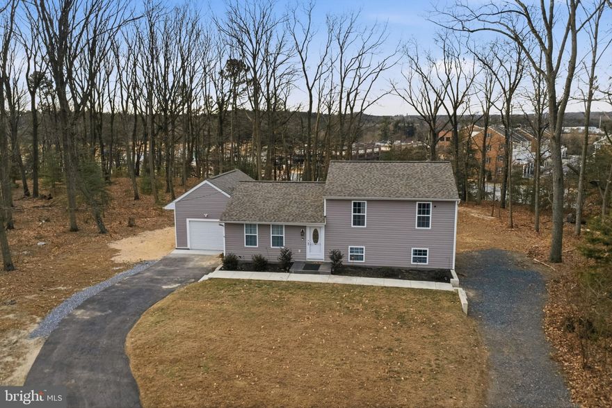 Welcome to your beautifully updated retreat, perfectly situated on **over an acre of private land** at the end of a quiet cul-de-sac—**close to everything, yet tucked into a peaceful, quiet neighborhood**. This move-in-ready home blends thoughtful renovations with generous living areas and exceptional outdoor amenities, all in a prime location near **BWI, Northrop Grumman, NSA, Ft. Meade, and Arundel Mills Mall**, and conveniently **situated between Baltimore and Annapolis**. Mature trees provide a gorgeous backdrop and a natural summer buffer, creating a truly serene setting.

The **open-concept main level** offers bright, seamless living with a spacious living room, dining area, and a fully renovated kitchen featuring **brand-new stainless steel appliances (2022)**. Sliding glass doors extend your living space onto a large deck overlooking a serene, tree-lined backyard—your own private oasis. The main level also provides convenient access to the attached garage.

Upstairs, you’ll find **three comfortable bedrooms** and a beautifully updated full bath. The lower level adds versatility with an additional living area and a **large primary suite** complete with a full bath and walk-in closet. This level also includes a half bath and a mudroom that opens directly to the backyard. A few steps down, a finished basement offers even more usable space along with a dedicated laundry area featuring an **LG large-capacity front-load washer and dryer**.

Outdoor living truly shines with a **24' round (5' center) Doughboy above-ground pool (2023)**—complete with all equipment—perfect for summer fun and weekend entertaining. The home also includes a **Provia front storm door and sliding glass door (2023)**, **added attic insulation (2023)** for improved efficiency, and a **well filtration and reverse osmosis system at the kitchen sink (2023)**. Additional upgrades include **luxury vinyl flooring in the basement (2024)**, a **generator panel and generator (2024)**, and **wiring for a propane-capable generator**. Major improvements continue with **electrical updates, an upgraded garage apron, and framing (2025)**. Big-ticket items were addressed early as well, including **well, septic, HVAC, water tank, deck, and both interior and exterior updates (2022)**—offering peace of mind for years to come.

With **no HOA and no water bill**, this property delivers the ideal blend of privacy, convenience, and modern comfort. For qualified buyers, an **assumable VA loan at 5.75%** with an approximate balance of **$560,000** adds a rare opportunity in today’s market. Schedule your showing today and experience everything this beautifully maintained home has to offer.