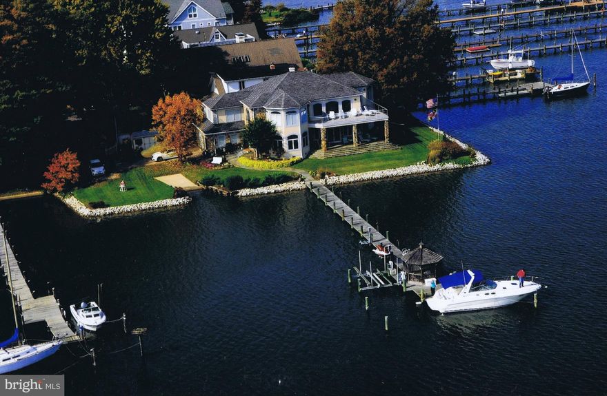 Boater's Dream Home! Custom arched Pella windows provide natural light & unparalleled views of the West River! Amazing details--Gourmet kitchen; Soaring stone FP;Brazilian cherry compass inlay in foyer;crown molding;custom cut glass panels;steam shower;Jacuzzi tub*Upper deck & covered porch w/ceiling fans on 2 sides of home*Patio*Dock w/gazebo, boat lift,2 jet ski lift+your own private boat ramp!