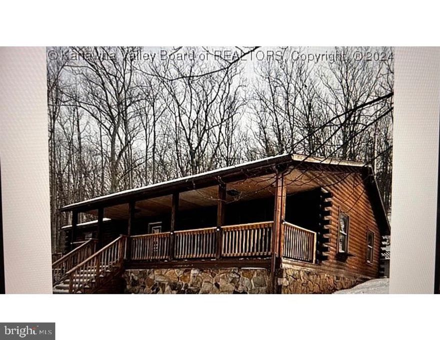 PERCHED on an expansive 9.98-acre canvas of natural beauty, this one-story log and stone cabin beckon those in search of a private haven. With rustic charm and modern luxury this home highlights 3 bedrooms and 2 full spa-like bathrooms. As you step inside the interior you will feel the warmth and inviting atmosphere with log elements throughout enhancing the cabin's character. A 2 stall horse barn along with a storage building and detached garage provide ample storage space. Privacy and breathtaking surroundings along with lake access will make this home exactly what you are looking for!