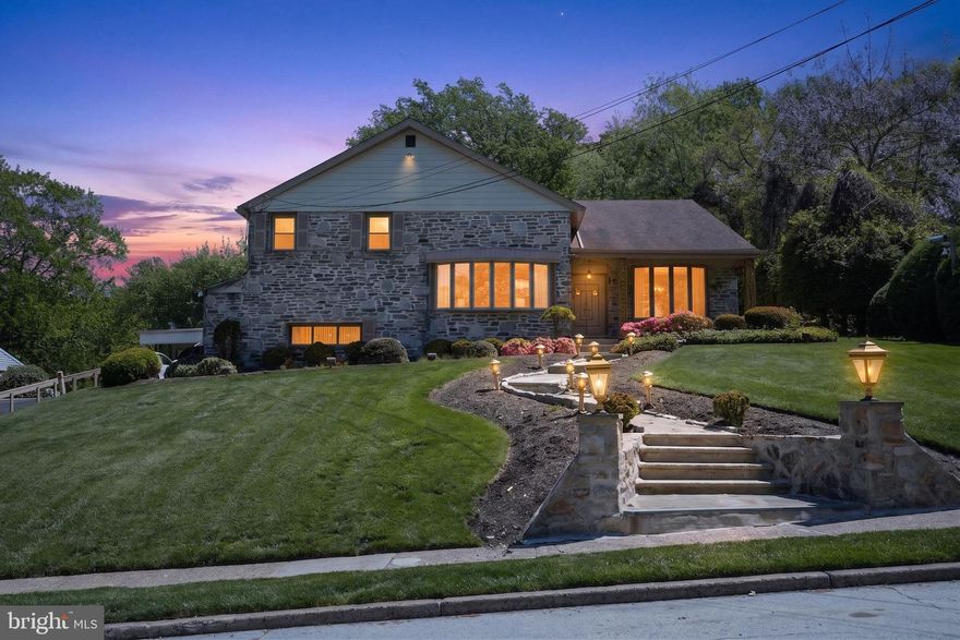Welcome to 1912 Cobden Rd — a spacious 4-bedroom, 4-bath home tucked into desirable Laverock and built for entertaining. The backyard is the showstopper: a large in-ground pool surrounded by an expansive patio with room for a crowd, a covered rear deck for shaded gatherings, and mature landscaping creating a private retreat. Inside, multiple living spaces flow across two levels — a vaulted-ceiling formal living room with bay window, a separate formal dining room, an eat-in kitchen, and a generous family room with fireplace. The lower level is the entertainer's prize: a full custom bar, lounge seating, and rec space that turns ordinary evenings into events. Covered carport plus attached garage round out a home offering generous proportions, exceptional indoor-outdoor flow, and unmatched entertaining capability.