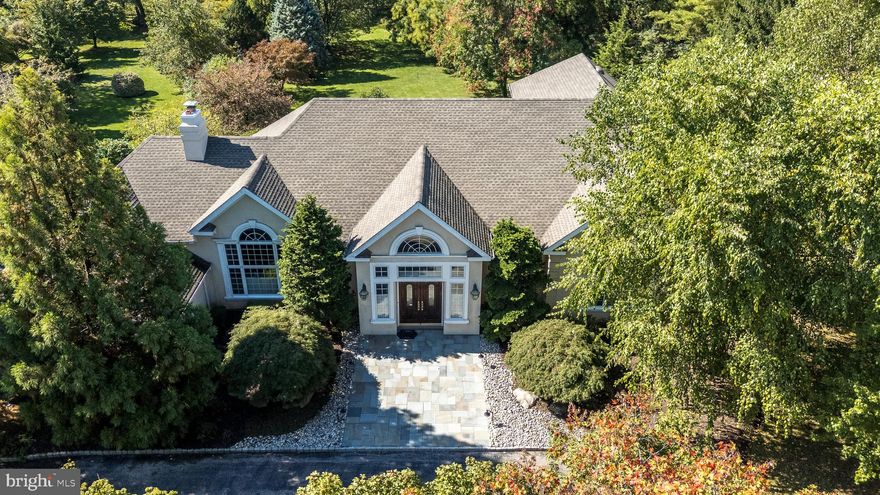 Gorgeous custom home, built by Sparango, with first floor Primary Suite and stunning open floor plan tucked away on 2 acres within a cul-de-sac in the heart of Blue Bell with spacious rooms and terrific amenities. There are 4 Bedrooms & 2.5 Baths including a 2nd Floor Loft with window and closet overlooking the 1st Floor Office that could easily be converted to the 4th Bedroom by adding a wall. From the moment you arrive, the property’s setting makes a lasting impression with beautifully landscaped grounds, mature specimen trees & shrubs and a sense of serenity that’s hard to find yet moments from everything this ideal location has to offer. The circular driveway is lined with cobblestones and leads to a new, large flagstone front Porch (2025). Step inside to immediately appreciate the spacious, open layout on the First Floor, filled with natural light, vaulted ceilings in every room, hardwood floors and a wonderful flow that makes each room feel connected yet distinct. The Entrance Hall opens to the Kitchen, Living, Dining and Family Rooms and features an atrium window over the double front doors, a Powder Room with marble floor, a coat closet and a curved hardwood staircase leading to the 2nd floor.  The incredibly spacious Kitchen offers granite counters, center island with 5 burner vented gas stove, 42” cabinets; wall of pantry closets w/extra deep shelves, GE Monogram built-in side-by-side refrig; and newer double wall ovens (2022) with WIFI. The adjoining breakfast area w/door to the Deck overlooks the backyard, ideal for enjoying a morning coffee while taking in the view. The Dining Room provides an outstanding entertaining space with a wall of windows, chair rail & extra-wide doorways as it flows to the sensational, sun-drenched Living Room which is the true centerpiece of this home, with another wall of windows, recessed lighting, chair rail and see-through opening to the 2nd Floor. The Family Room, also accessed from the center hall, features a gas fireplace w/floor-to-ceiling stone surround & raised stone hearth, & a built-in bar w/granite counter, cabinets & glass shelves. Work from home in the stunning Office/Library with built-in custom cabinetry and shelving with a unique extended lighting fixture and a view of the 2nd Floor Loft. A true highlight of the home is the first-floor primary suite, offering the ease of one-level living & a private retreat all its own w/wall-to-wall carpet and triple wide custom, built-in cabinets, 2 walk-in professionally organized closets and a Full Bath with tiled floor, 2 vanities with corian counters, whirlpool tub & stall shower w/frameless glass door & bench seat. The Laundry Room, adjacent to the Kitchen includes the washer, dryer, utility sink, 42” cabinets, custom built-in drying racks & an extra freezer. The Mud Room w/tiled floor and closets provides a side door to the exterior and also opens to the 3-Car Garage w/extra refrig. A curved hardwood staircase leads to the 2nd floor. 2 Bedrooms with wall-to-wall carpet share the Full Hall Bath with soaking tub & shower. The 2nd Floor Loft/possible 4th Bedroom with window and closet overlooks the 1st Floor Office. Unlimited opportunities await in the unfinished, walkout Lower Level which provides 2 hot water heaters and 2 gas furnaces, plus it is already plumbed for a future bathroom. Outside, the expansive two-acre lot, with split rail fence on 3 sides, provides endless opportunities, from creating an outdoor oasis or pool to enjoying peaceful mornings on the Deck or hosting summer gatherings in a private, park-like setting. Other special features include a Generator, new roof (2022) & Pella windows throughout. Located in one of the most sought-after areas in Blue Bell, this home offers the perfect blend of tranquility and convenience, within top-rated Wissahickon School district and close to private schools, parks, golf courses, shops, & excellent restaurants, with easy access to all major routes. Come See!