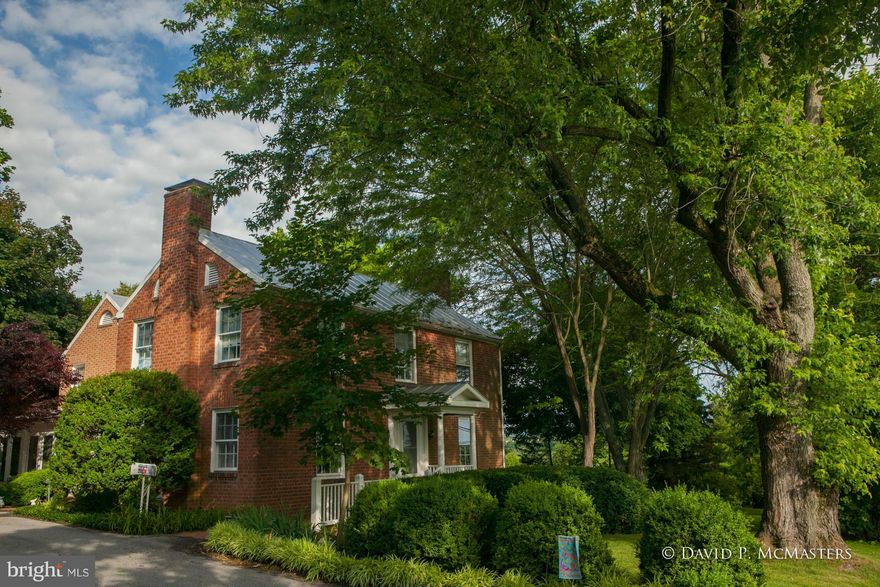 Its a classy charmer.  Brick veneer, restored, tastefully renovated Federal style home on 2 Acres.  Beautiful estate setting,grounds;  mature trees, plantings.  Wonderful brick patio overlooks lawns, gardens.  4 Fireplaces. Great family room for entertaining  opens w/ French doors to patio, sunroom and lawns. High Quality. Immaculate. Storage barn, brick potting house/studio. Convenient location.