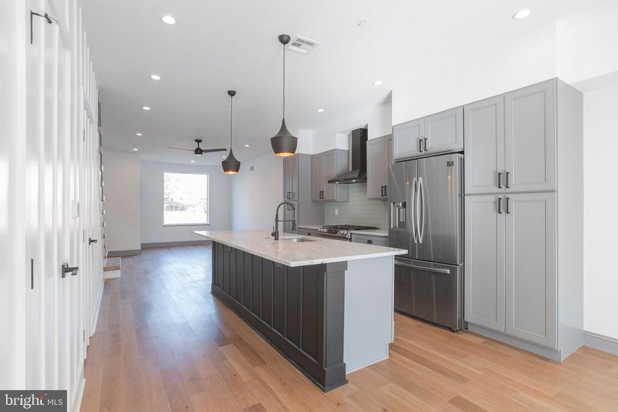 This is not a drill! Another Shearman special is available in prime 19125! This MASSIVE 3,500 sqft stunner has been thoughtfully curated by one of the top custom home builders in Philadelphia – Shearman Homes. No detail was untouched in design from exterior to interior. The grand 2 story exterior wood entrance will wow you from the street along with the gorgeous brick façade. The front door is tucked away so that you can appreciate the exterior as well as properly use the interior living space. Every inch of this 18’ wide home is used efficiently from the large living and dining rooms to the HUGE kitchen. Shearman takes it to another level by reclaiming old barn wood to use in the first-floor staircase. Heavy trim details make this level special along with the hidden entrance to the basement and first floor powder room. The huge backyard is cemented and mulched so that you can create your own oasis for you and your four-legged friends. The lower level is fully finished with industrial polished concrete floors, plenty of storage space, and a large full bathroom. As you ascend to the second level, you will find two massive bedrooms, a conveniently placed laundry room and a large full bathroom. Natural light POURS through the nearly floor to ceiling windows. The third level primary suite is special in itself. First, you will notice a massive wet-bar, perfect for rooftop entertaining, but also great to create your own coffee station. The huge bedroom features a massive walk-in closet and spa-like ensuite fully outfitted with all the necessities plus a few luxuries. You will also enjoy a little private outdoor space off your bedroom. The home concludes with a large rooftop deck with rubber surface – this upgraded material will be easy to maintain and hold for a long time. Schedule your tour now! This home won’t be waiting for you.