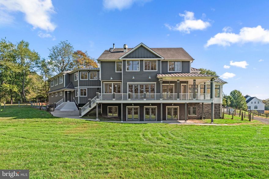 Welcome to 3216 Ramsland Way in sought after Urbana MD. This custom-built home from Lancaster Craftsmen Builders is a testament to quality construction in every way. Boasting approximately 6,378 sf of living space on over 2 acres, this home will resonate with savvy homebuyers looking for quality construction, acres of useable yard space and of course location, location, location. Situated conveniently on a cul de sac, just a half mile from I-270 and minutes to restaurants, groceries and within the sought after Urbana school district.
As soon as you see the home you’ll fall in love with it’s Coastal Farmhouse architecture. The wrap around porch will draw you into the views of Sugarloaf Mountain, scenic farmland and beautiful sunrises. 
Upon entering the foyer you’ll notice the 10’ ceilings, 8’ interior doors and the openness of the floorplan which is perfect for entertaining. You’ll immediately be drawn to the kitchen where you will quickly realize that gourmet is an understatement. Adorned with two 12’ islands, 48” commercial stainless cooktop with griddle and 30” indoor grill, beautiful custom white cabinets and soapstone countertops. Top it off w/ a built in Mugnaini  wood-fired oven imported from Italy. Pizza night will never be the same again.
Additional kitchen features are 2 – dual drawer under counter refrigerators, undercounter icemaker, large walk-in pantry, veggie sink and undercounter wine refrigerator to name a few. Just off the kitchen is the dining area which has a 12’ accordion exterior door that opens to the deck for an Al-Fresco dining experience. Gorgeous wide plank Hickory hardwood floors tie the main level together seamlessly until you step into the solarium. This is a room you must see for yourself. The vaulted-beamed ceiling, natural stone flooring and views from the abundant windows are amazing. 
Rounding out the main level is the great room with doors leading to the rear covered porch, living room with box bay window, and huge mudroom off the kitchen leading to the oversized 3 car garage. 
The upper level follows suit and doesn’t disappoint. The wide plank Hickory floors sweep through all the rooms upstairs. Double doors at the top of the stairs lead to the huge primary suite. The bedroom is elegantly designed with sloped ceilings, custom-built in storage and window seat. The focus of the owner’s bathroom is the huge walk-in, zero threshold shower, along with both a rain can and handheld shower heads. You’ll notice the warmth of the heated floor as soon as you step out. Additional features are huge walk-in closet and a separate water closet w/ vanity.
The upper-level laundry room comes complete with laundry sink next to the washer/dryer, and cabinets and countertops for storage and folding.
Rounding out the upper level with spacious secondary bedroom with walk-in closet, full bathroom, flex area for playroom or study area which leads to a huge area above garage that’s ready for your imagination. 4th BR, In-law suite, huge office/playroom. It’s ready for anything. Includes a rough in for future bathroom, zoned heating and cooling and a staircase to the garage.
Natural light is abundant in this home and a full walkout basement across the rear allows for three glass double French doors and a pair of twin windows. The huge rec room spans the rear of the home and lower level includes 9’ ceilings, a large wet bar with dishwasher and refrigerator, full bath w/ standing shower, large legal bedroom with walk in closet and considerable storage space.
The exterior is high quality, low maintenance products such as Hardie Plank siding, composite decking w/ AZEK railing, 50 yr architectural shingle on main upper roof w/ 100 yr standing seam metal on remainder, Aluminum clad Marvin windows and doors, geothermal hvac, 17KW whole house generator.
An amazing home, on an amazing homesite, in an amazing location.