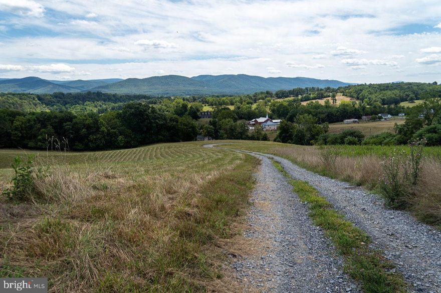 Welcome to Galloway Springs Farm, where privacy, panoramic views, and endless outdoor recreation come together on this stunning 7+ acre tract. Enjoy breathtaking mountain and river views in a peaceful setting that feels worlds away — yet remains conveniently located just 30 minutes from Harrisonburg, a little over an hour to Charlottesville, and under two hours to both Washington, D.C. and Richmond. Zoned Agricultural and currently producing hay, this property qualifies for land use tax reduction, keeping annual real estate taxes extremely low. With NO HOA and two short-term vacation rentals permitted by right, the possibilities are wide open — whether you are envisioning a private homestead, weekend retreat, investment property, or small farm. Outdoor enthusiasts will appreciate the close proximity to the South Fork of the Shenandoah River, with a public boat landing nearby for easy river access. The property is also minutes from the George Washington National Forest, Shenandoah National Park, Luray Caverns, and Massanutten Resort — offering year-round adventure. Improvements already in place include a gravel driveway, completed survey, and a three-bedroom septic letter on file — making this property ready for your vision. Don’t miss your opportunity to own a beautiful farmette in the “Cabin Capital of Virginia,” where scenic beauty and opportunity meet.