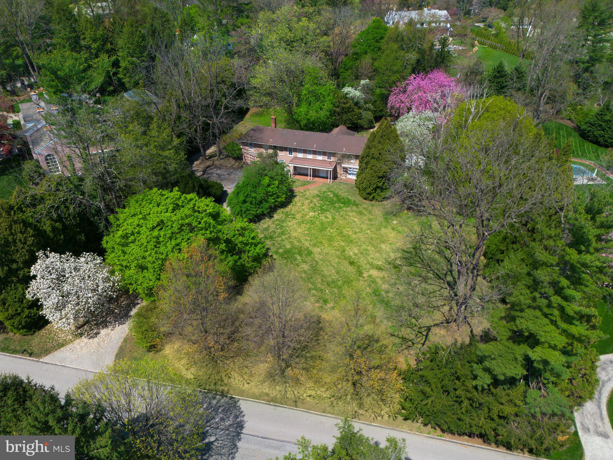 Located on one of north-side Villanova’s most prestigious and sought-after streets, 1114 Brynlawn Road offers a rare opportunity to restore or reimagine a classic Main Line estate.
Set on 1.35 level acres with expansive frontage and an in-ground pool, this 7-bedroom, 5.5-bath Walter Durham residence is surrounded by some of the area’s most significant homes. The street forms a quiet, two-road circle with virtually no through traffic—an ideal setting for privacy, serenity, and long-term value.
The home’s traditional layout features a wood-paneled foyer, a spacious living room with fireplace, and a beautifully proportioned dining room with built-in china cabinets and French doors that open to the rear grounds. The galley-style kitchen adjoins a mudroom and laundry area, while a cozy den with built-ins provides a quiet retreat. A powder room and unfinished basement complete the main level.
Upstairs, seven bedrooms with hardwood flooring and five full baths offer remarkable space and flexibility for family living or future redesign. The home’s footprint and the generous, level lot easily support a substantial addition or expansion.
Central air is in place, but the home will require extensive renovation to reach its full potential. Whether preserved and restored or fully transformed, 1114 Brynlawn Road presents a rare chance to own a legacy property in one of the Main Line’s most exclusive locations.