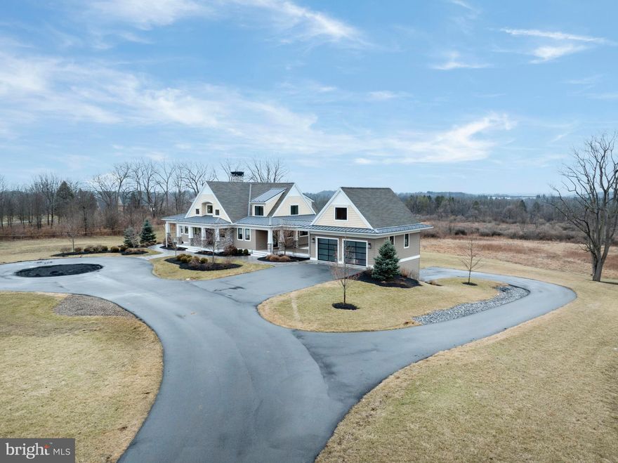 OPEN HOUSE: Sun, Apr 19 1:00 PM - 3:00 PM | Welcome to a truly exceptional Craftsman estate where timeless architecture meets modern luxury, set on 16.56 breathtaking acres of rolling beauty and serene privacy. This remarkable 4-bedroom, 5½-bath home offers the perfect blend of refined living and relaxed comfort, thoughtfully designed for both everyday enjoyment and unforgettable gatherings. Step inside to discover a warm, open main level filled with natural light and refined finishes. At the heart of the home, the expansive chef’s kitchen is a true showpiece—featuring high-end appliances, generous counter space, custom cabinetry, aesthetically pleasing lighting and an inviting layout that makes cooking and entertaining effortless. Whether hosting holiday celebrations or enjoying a quiet morning coffee, this space was designed to bring people together. The adjoining living area flows beautifully, offering cozy yet sophisticated spaces anchored by Craftsman-style details and picturesque views of the surrounding acreage. Large windows frame the natural landscape, creating a seamless connection between indoor comfort and outdoor beauty. Throughout the home, each of the bedrooms offers privacy and comfort, while the 5½ bathrooms provide convenience and thoughtful design. The luxurious primary suite serves as a peaceful sanctuary, offering ample space to unwind at the end of the day. Downstairs, the fully finished lower level expands the home’s versatility even further. A complete second kitchen makes this level ideal for extended family living, guest accommodations, or effortless entertaining. Whether hosting long-term visitors or creating the ultimate game and movie night space, this level offers endless possibilities. Above the main-level two-car garage, a separate living space provides even more versatility. Perfect for a guest suite, home office, studio, or private retreat, it adds yet another layer of functionality to this already exceptional property. In addition to the main-level garage, a second two-car garage on the lower level ensures abundant storage for vehicles, equipment, or recreational toys.
Perhaps the most enchanting feature of all is the covered porch that stretches across the entire back of the home. This expansive outdoor living space invites you to slow down and savor the views—morning sunrises, golden afternoons, and peaceful evenings surrounded by nature. With 16.56 acres to explore, complete with scenic walking paths, you’ll enjoy privacy, beauty, and room to roam right outside your door.
This is more than a home—it’s a lifestyle. A rare opportunity to own a Craftsman estate where luxury, land, and livability come together in perfect harmony.