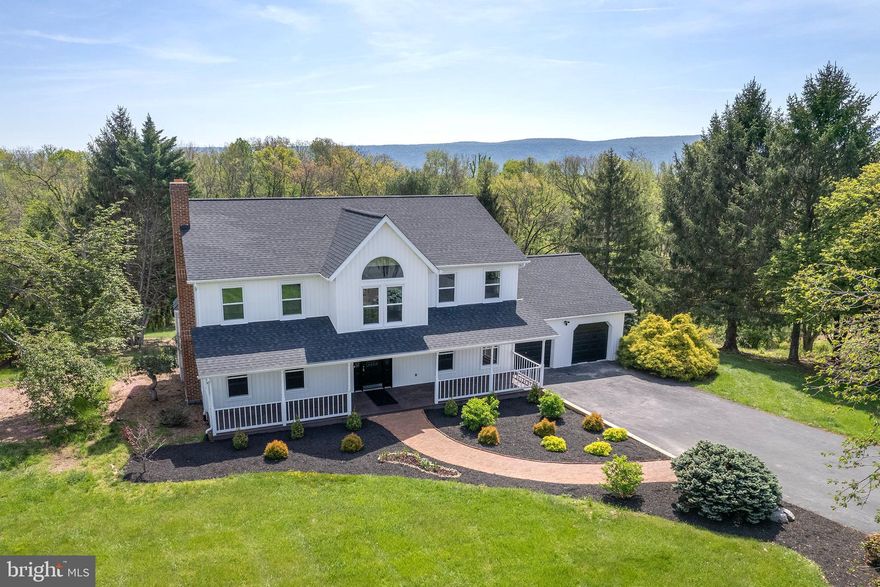 Meticulously Renovated Colonial on 2.15 Acres with In-Law Suite & Smart Features

Welcome to this exquisitely renovated 4-bedroom, 4.5-bath Colonial in the prestigious Spring Hollow Estates. Set on a private 2.15-acre lot, this nearly 5,000 sq ft residence blends timeless architecture with high-end modern upgrades—just a couple minutes from I-81 and the vibrant town of Woodstock.

Renovated to an exceptional standard, this home features hardwood flooring across all three levels, elegant tilework, custom millwork, and refined lighting throughout. The main level includes formal living and dining rooms with crown molding and chair rail, a sunlit living room centered around an unused brick fireplace, and a designer kitchen with quartz countertops, smart stainless steel appliances, and abundant natural light.
Upstairs, the spacious primary suite offers a spa-like bath with a freestanding soaking tub, glass-enclosed shower, and marble-topped dual vanity. One additional bedroom includes a private en-suite bath, while two more bedrooms share a third full bath—perfect for family or guests.

The fully finished walk-out lower level features a complete in-law suite with a kitchenette, full bath with marble vanity, private laundry, and its own entrance—ideal for multigenerational living or flexible accommodations.

Step out from the family room onto a maintenance-free composite deck with peaceful easterly views. The backyard backs to mature woods and enjoys exceptional privacy with no neighbors on two sides.

Key Features and Recent Upgrades:

New energy-efficient windows throughout

New roof, heat pump, and water treatment system with two new hot water tanks

Smart switches, USB outlets, and Google Nest thermostats

Smart appliances and 4-camera Ring security system

Oversized 2-car garage with new garage door opener and decorative flooring

Extensive mechanical improvements throughout

This move-in-ready home delivers space, quality, and smart living in one of Woodstock’s most desirable neighborhoods