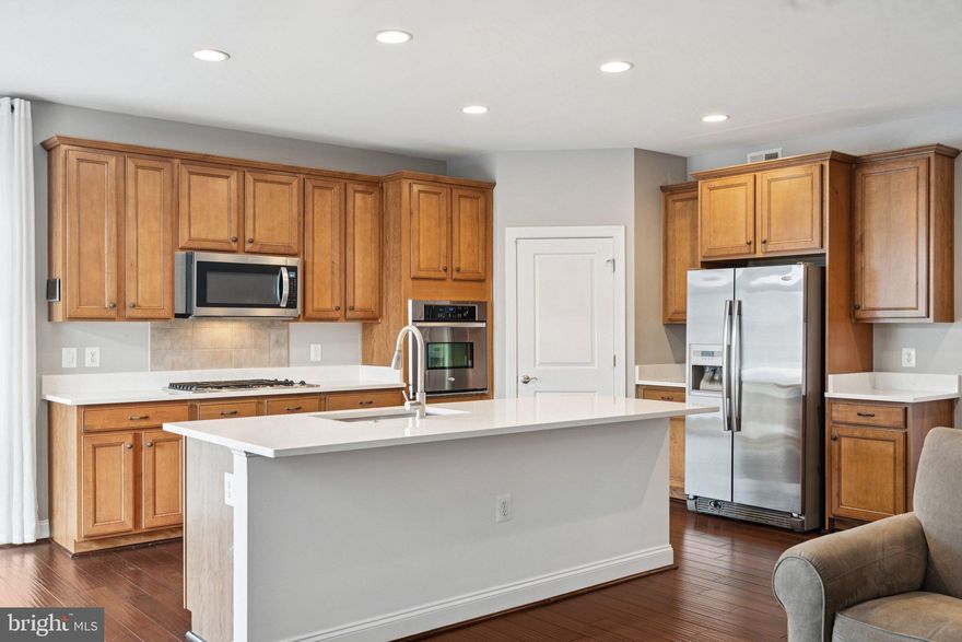 Experience the best of Trilogy at Lake Frederick's 55+ community with main level living in this beautifully crafted home, where comfort, elegance, and versatility come together in perfect harmony. From the moment you step inside, you'll be welcomed by rich hardwood floors and an abundance of natural light that accentuates the home’s warm, inviting ambiance.
<br><br>
Perfect for entertaining and everyday living, the layout includes formal living and dining rooms and a stunning gourmet kitchen recently updated with gorgeous Quartz counters. Thoughtfully designed, the kitchen boasts newly installed countertops, new dishwasher, a generous center island with seating, sleek quartz surfaces, and ample cabinetry. It opens seamlessly to the spacious family room—creating a central gathering space where connection and comfort come naturally.
<br><br>
Just beyond, step out onto an impressive 36' x 12' Trex deck bordered by crisp white vinyl railings. This expansive outdoor retreat overlooks a fully fenced backyard, enclosed with low-maintenance white vinyl fencing and two convenient access gates, as well as a lower-level paver patio—an ideal setting for outdoor dining, relaxing, or entertaining.
<br><br>
The main level primary suite serves as a true retreat, complete with an oversized walk-in shower and spa-inspired finishes, completely remodeled in 2025. A second bedroom and full bath, along with a dedicated laundry room, complete this thoughtfully designed level.
<br><br>
Downstairs, the fully finished walk-out basement enhances the home’s functionality with a spacious recreation area and two additional finished rooms—perfect for home offices, creative spaces, or welcoming overnight guests.
<br><br>
Additional highlights include a two-car garage with gleaming epoxy-coated flooring, a recently sealed driveway, and a fully equipped alarm system for peace of mind.
<br><br>
This home has been meticulously maintained and thoughtfully upgraded with over $60,000 in improvements. Notable updates include a tankless water heater installed in 2026, a full renovation of the luxurious primary bathroom in 2025, new washer and dryer in 2021, newly installed kitchen countertops, fresh interior paint, and a durable white vinyl fence with two gates added in 2014. These enhancements ensure both modern comfort and long-term value in a location that offers close proximity to major shopping centers, everyday amenities, and key commuter routes.
<br><br>
As a resident of Trilogy at Lake Frederick, the region's premiere 55+ community, you'll enjoy a wealth of incredible amenities designed to enhance your lifestyle. Dive into relaxation with both indoor and outdoor pools, stay active in the state-of-the-art fitness center, and unwind at the well-equipped community clubhouse. Savor gourmet meals at the farm-to-table restaurant and socialize in the exclusive members-only lounge. For the sports enthusiasts, tennis and pickleball courts, as well as a dog park, offer ample opportunities for recreation, while extensive lake trails beckon for serene strolls and outdoor adventures. Join a vibrant community of welcoming neighbors and future friends. Experience the pinnacle of resort living at Trilogy at Lake Frederick—where your dream home and ideal lifestyle come together seamlessly.