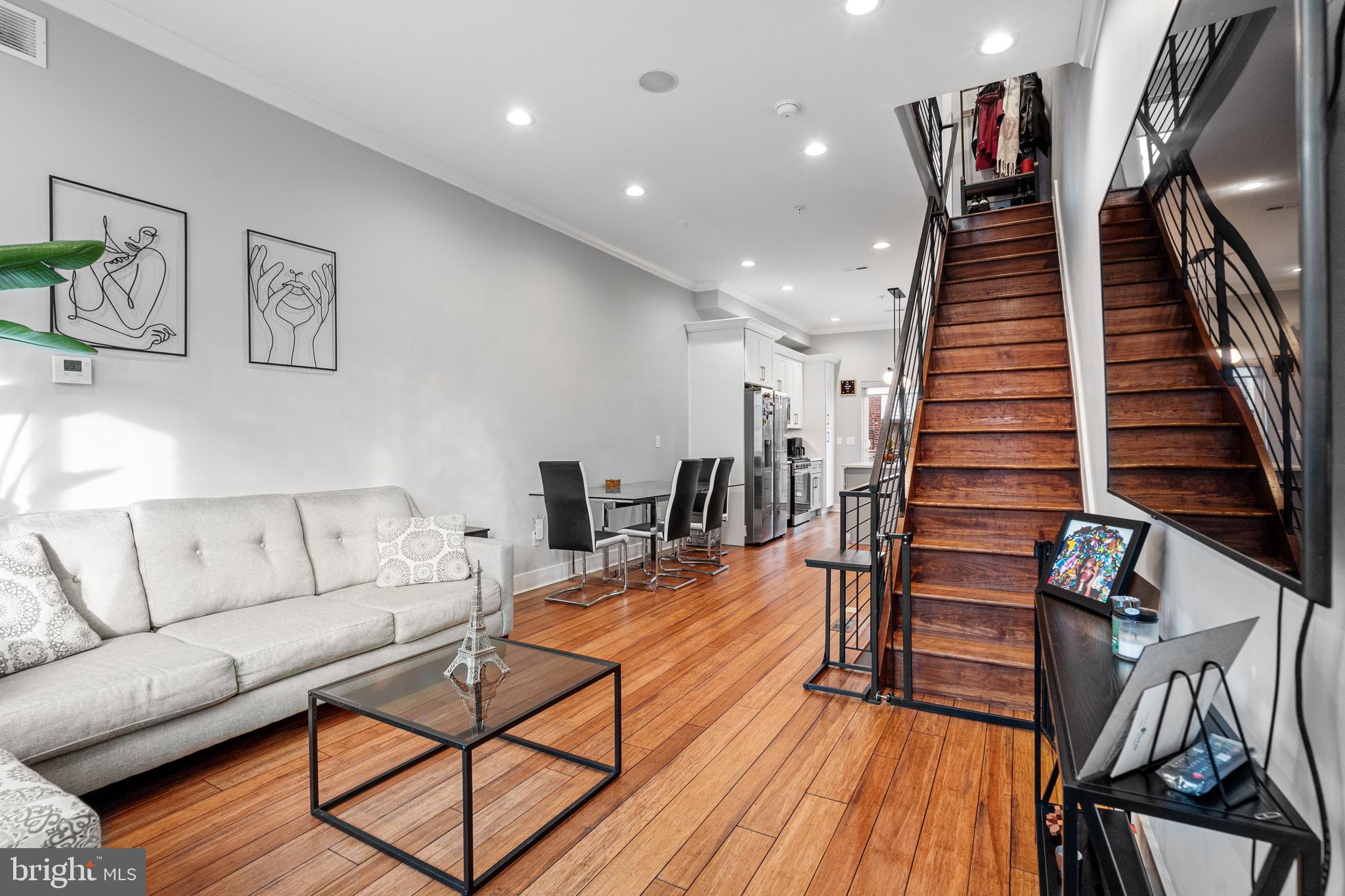 Welcome to 1751 S Taylor Street, a dazzling, three-year-old gem in the heart of South Philly’s most vibrant and sought-after neighborhood! This 2022-built beauty radiates modern elegance with stunning hand-scraped hardwood floors, sophisticated crown molding, and intricate custom millwork throughout. The chef’s kitchen is a true masterpiece, featuring a sprawling island, top-tier Samsung Stainless Appliances, soft-close Shaker cabinetry, and sleek solid stone countertops that make cooking feel like a luxury experience. Pamper yourself in the spa-inspired bathrooms, where imported Porcelain & Marble tiles, seamless glass showers, and modern freestanding tubs with rainfall shower heads create the ultimate relaxation haven. The Master Suite is your personal sanctuary, with a sun-drenched bay window and a spacious walk-in closet. And just upstairs, your private rooftop deck offers jaw-dropping 360-degree views of the Philadelphia skyline—an entertainer’s dream!
With cutting-edge SmartHome technology, including WiFi Thermostats, Smart Deadbolts, and RING Video Doorbells, you can control your home with ease, whether you’re lounging on your rooftop or away on vacation. Bluetooth surround sound and convenient USB outlets elevate your living experience. The full backyard provides the perfect space for grilling, lounging, or enjoying a peaceful retreat. Step outside and you’re just moments from the best of South Philly—Dock Street Brewery, South Philadelphia Tap Room, Sardine Bar, and an array of eclectic restaurants and bars. With 7 years left on the 10-Year Tax Abatement, this isn’t just a stunning home—it’s an exceptional investment. In addition, this home qualifies for $10,000+ in grants for owner occupants, contact the listing agent for details! Don’t miss your chance to own a slice of this dynamic, rapidly-growing community – schedule your tour today!