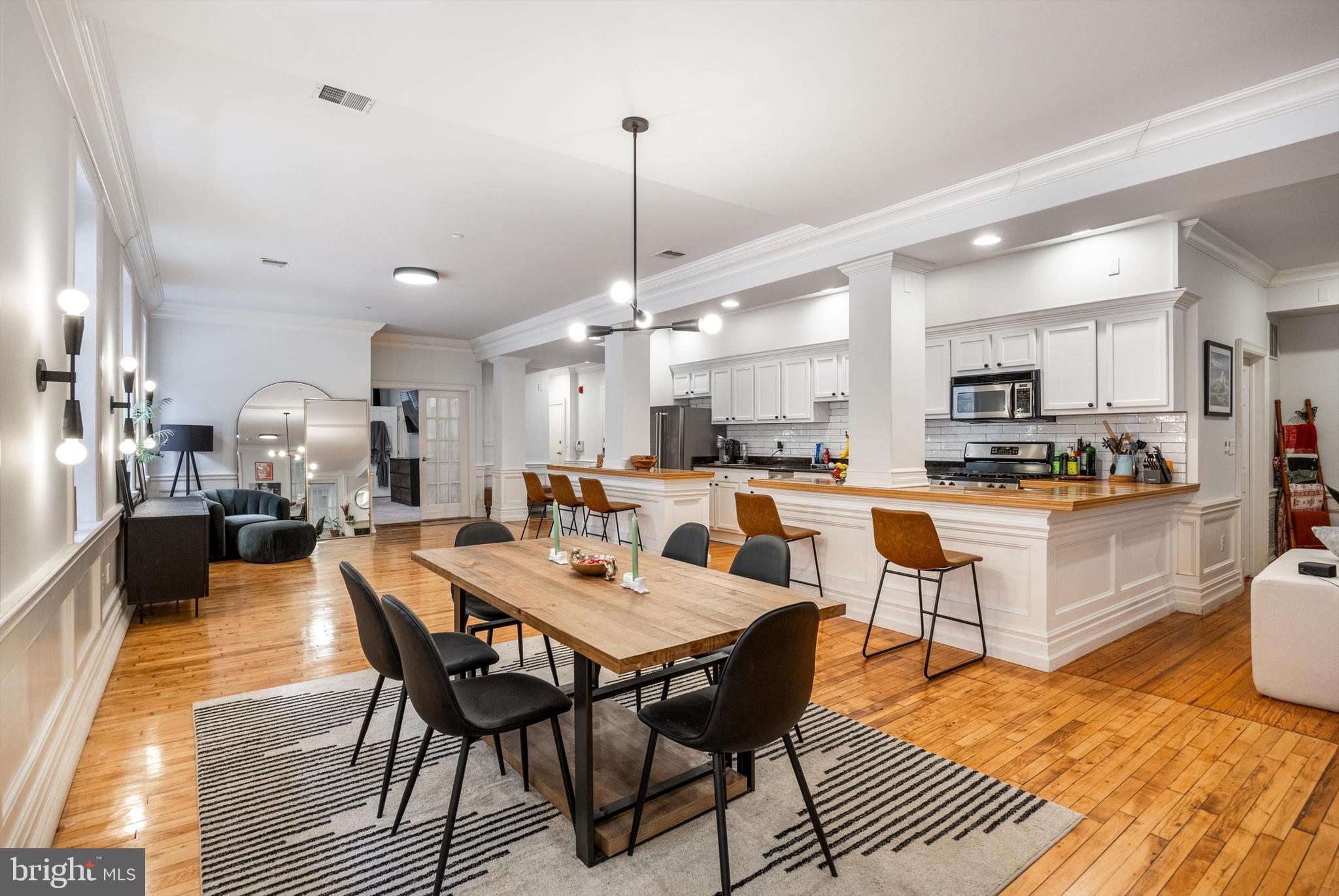 Set in the heart of Philadelphia's historic Old City, Hamilton Hall Condominiums offers one-of-a-kind full-floor lofts that will make you feel like you're living in a movie! Featuring an open floor plan with a massive wall of oversized windows and 10-foot ceilings, this light-filled condo is an absolute jaw-dropper.
Conveniently located on the second floor, the unit is easily accessible by the stairs, or if you prefer, you can use the private elevator, which opens up directly into your living space. The massive chef's kitchen sits at the center of the space, ideal for day-to-day living and entertaining. The ample open space in the center can be set up as a dining room, sitting area, office space - or whatever else you might dream up. Just past the kitchen, you'll find the perfect nook for a TV/den area, complete with a gas fireplace. A full bathroom and laundry room are hidden behind the kitchen, convenient but out of the way.
The primary suite is set at the near end of the unit, closest to the elevator, offering privacy and additional windows along the west wall of the building. At the far end, you'll find two additional bedrooms, either of which could double as a wonderful home office.
Living in Old City, Philadelphia's historic heart, you'll be steps from neighborhood staples like Race Street Cafe, Fork, and Cafe Ole, along with great shopping, boutiques, and a vibrant arts scene. You'll also be an easy walk to the new 11.5-acre park being developed at Penn's Landing, Independence Mall, and Washington and Franklin Squares. If you need to commute to the burbs, you'll be on the expressway or over the bridge in seconds. Last but not least, parking is a breeze with the Old City Parkominium literally around the corner.