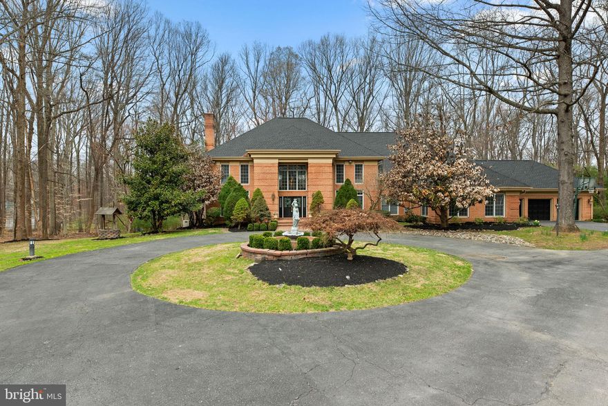 Coming Soon! Extraordinary brick Colonial estate offering over 9,700 total square feet, gracefully set on a private 5-acre homesite in prestigious The Preserve at Burleigh Manor, surrounded by serene wooded views. A long, circular driveway creates a grand sense of arrival, setting the stage for the refined elegance found throughout. Inside, timeless luxury and expert craftsmanship are on full display. A breathtaking two-story foyer with marble flooring and a dramatic dual curved staircase, illuminated by a dazzling crystal chandelier, makes an unforgettable first impression. Rich hardwood floors flow seamlessly through the formal dining room, private study, elegant living room with a gas fireplace, and the inviting family room, also anchored by a gas fireplace. The stunning eat-in kitchen is thoughtfully designed with stainless steel appliances, granite countertops, an island, a breakfast bar, and ample space for everyday living and entertaining. A well-appointed main-level bedroom suite offers exceptional flexibility, ideal for multigenerational living or private guest accommodations, while four additional bedrooms are thoughtfully positioned on the upper level. The primary suite is a true retreat, featuring a private enclosed screened porch, a spacious sitting room, dual walk-in closets, and a luxurious en-suite bath appointed with marble flooring. The fully finished walk-out lower level is an entertainer’s dream, complete with a built-in bar and expansive, versatile spaces ideal for lounging, recreation, a home gym, or hosting gatherings. Outdoor living is equally impressive, with two screened porches, a deck, and a patio overlooking a beautifully landscaped backyard that backs to mature trees, offering both privacy and a picturesque natural setting. Recent updates include the roof and HVAC in 2025, water heater in 2024, and an upper-level bathroom renovation in 2026, offering added peace of mind.