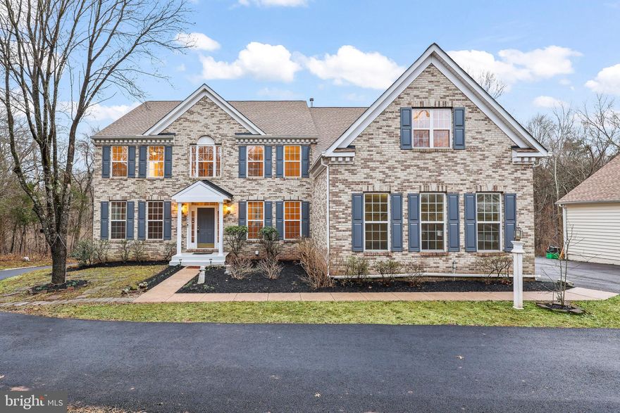 This gorgeous home is an absolute retreat! Nestled on 10.5 acres in the desirable Paddocks at Dowden Downs, it offers a serene escape with plenty of space to stretch out. The well-maintained brick-front exterior complements the expansive almost 6,000 sq/ft of living space across 3 finished levels, including a walk-out basement. With a 3-car side-load garage & 2-car detached garage, you’ll have all the storage you need. Inside, enjoy freshly painted walls and brand-new carpeting throughout. Enjoy breathtaking views of the scenic woods from every window in the house! The grand 2-story foyer and family room make a stunning first impression, while the open layout provides a natural flow between the living and dining rooms. With 5 spacious bedrooms and 4.5 bathrooms, this home provides ample space for comfortable living. The main level features gleaming hardwood floors, formal living and dining rooms and main level library for a quiet retreat. The expansive 2-story family room has a gas fireplace and is adjacent to the gourmet kitchen featuring granite countertops, stainless steel appliances, a brand new gas cooktop, center island, breakfast bar, and walk-in pantry. The kitchen opens to a sunny morning room with access to the large trex deck, perfect for your outdoor entertaining  & barbecues and stunning views of the woods. The upper level has 4 bedrooms and 3 full bathrooms. The primary suite features a sitting room, his & her closets, and an en-suite primary bathroom with dual vanity, separate shower, and soaking tub with whirlpool jets. There is an extra bonus room off the primary bathroom which can be used as closet/den/office.  Entertain in the lower level which includes a large recreation room for family fun, 5th bedroom, 4th full bathroom, kitchenette and a 2nd laundry room, den/office and has a walk-out to the private backyard offering beautiful wooded views of the  landscape! This home combines luxury, space, and nature for a perfect living experience. Some of the recent updates include Roof - 3 years, water heater - 3 years.