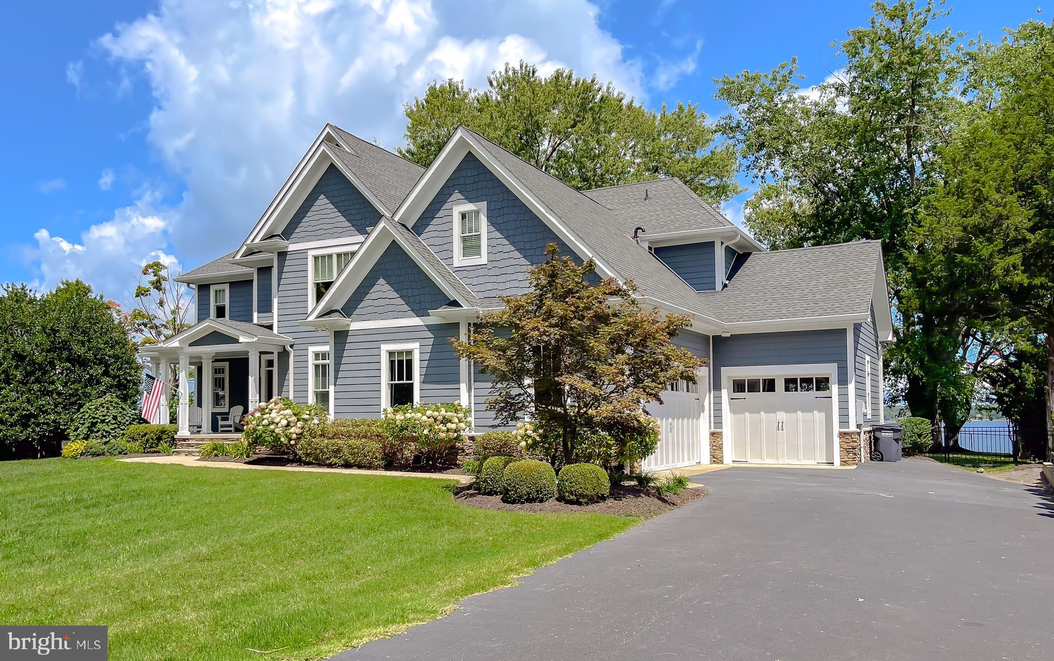 Waterfront Craftsman on the Patuxent River – Built for Coastal Living
Experience the perfect blend of luxury and lifestyle in this stunning 2015 waterfront Craftsman home nestled on the Patuxent River. Designed for comfort and entertaining, the home showcases panoramic water views, a flowing open floor plan, and high-end finishes throughout.
The heart of the home is the gourmet kitchen, featuring custom Woodburn's cabinetry, a designer tile backsplash, walk-in pantry, and adjoining formal dining space—perfect for hosting gatherings. Elegant coffered ceilings, extensive trim work, and custom built-ins enhance the home’s refined character, while hand-scraped hardwood flooring, stone, and tile add warmth and texture.
An adjoining main-level in-law or guest suite includes its own full kitchen and laundry, offering privacy and flexibility for multi-generational living or long-term guests. A dedicated home office adds convenience for today’s work-from-home needs.
Upstairs, you’ll find the spacious primary ensuite bedroom with a luxurious bath and custom closets, along with three additional bedrooms and two full baths. Two versatile flex rooms provide extra space for a media room, gym, or play area.
Outdoor living is equally impressive, with covered spaces on both levels for relaxing or entertaining, and a private pier ideal for boating, crabbing, and watersports.
The property also includes 1,060 sq ft of garage space, including a 35’ x 23’ two-car garage and a full-through third bay—perfect for storing lawn equipment, dock supplies, or recreational gear. Additional highlights include a geothermal heating and cooling system, yard irrigation, generator backup, and an expansive unfinished lower level ready for your personal touch.