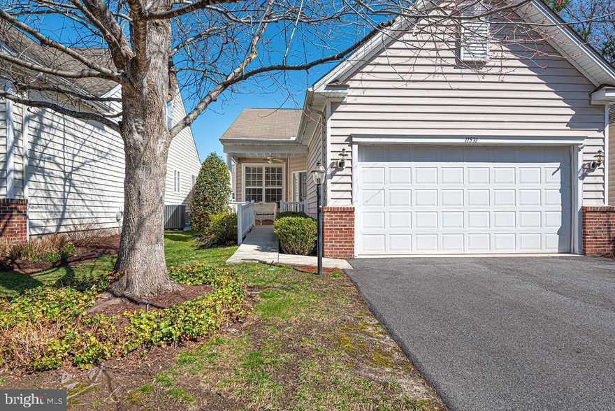 Welcome to this beautifully maintained Cormorant model home in the highly sought-after Premier Plus 55+ community of the Parke at Ocean Pines. This charming 3-bedroom, 2-bath residence offers the perfect blend of comfort, style, and low-maintenance living. A welcoming front courtyard sets the tone for this inviting home—perfect for relaxing mornings or greeting guests. Step inside to discover an upgraded kitchen designed for both function and style, featuring a center island, pull-out cabinetry, an oversized pantry, and a bright breakfast room ideal for casual dining. Hardwood flooring flows throughout the kitchen, hallway, great room, and third bedroom or den, creating a warm and cohesive living space. The spacious great room is enhanced by elegant crown molding, which continues throughout the home, adding a refined touch to every room. The versatile third bedroom can easily serve as a den or home office. The primary suite offers a comfortable retreat with plush carpeting, while the secondary bathroom has been thoughtfully updated with a new handicap-accessible tub/shower combination. Additional highlights include a large laundry room complete with a laundry tub, a wheelchair ramp in the garage for enhanced accessibility, an encapsulated crawl space for improved energy efficiency and moisture control, and a newer roof providing added peace of mind. Step outside to a beautifully landscaped backyard featuring a brick paver patio overlooking a serene small pond—perfect for entertaining or enjoying peaceful evenings surrounded by nature. Complete with a 2-car garage and located in a vibrant, amenity-rich community, this home offers easy living at its finest. Don’t miss your opportunity to enjoy everything the Parke at Ocean Pines lifestyle has to offer!