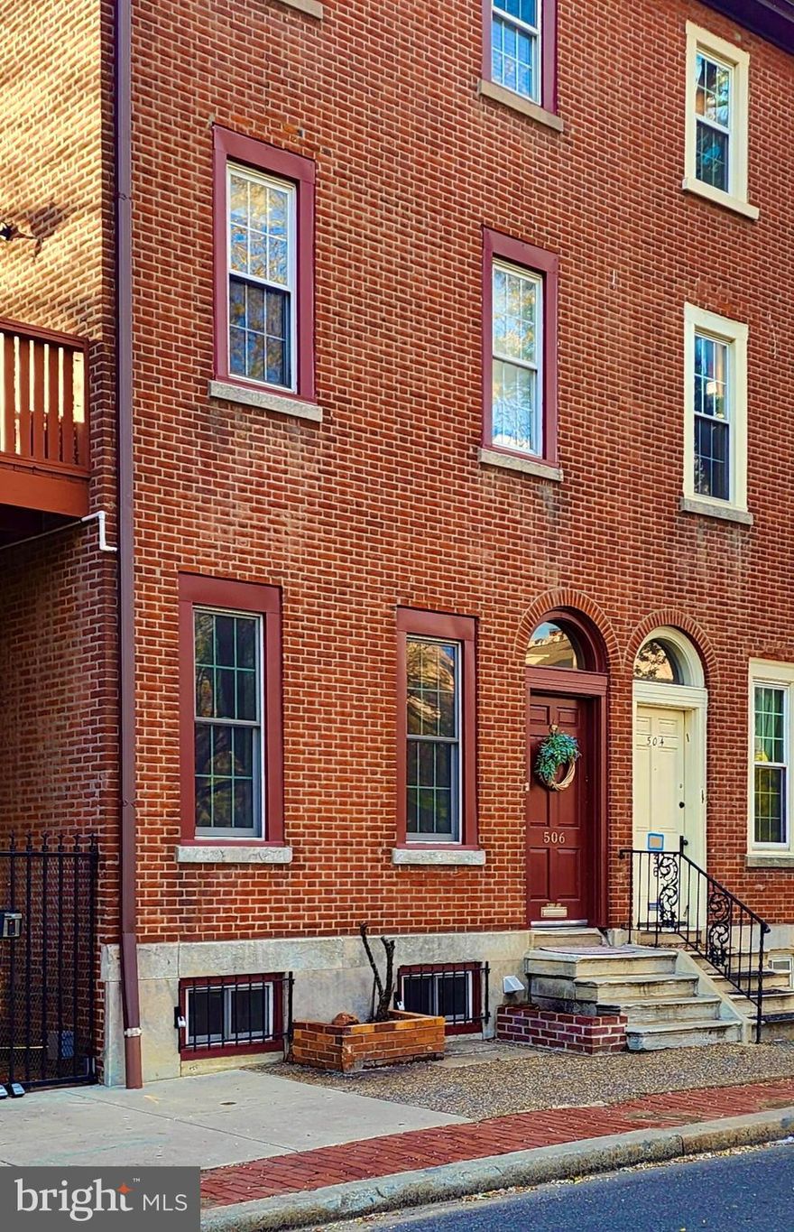 Located in the prestigious WASHINGTON SQ WEST neighborhood of Philadelphia,  This unique and historic brick home has old world charm with updated amenities. Enter the front door into  a light filled  foyer with warm wood floors and access to two bedrooms and a full bath. The loft style Main bedroom is spacious  with a huge window making it bright and cheerful with plenty of storage and a large double closet. This bedroom has a balcony which overlooks the lower level living room. The second bedroom is smaller and could also be used as an office or nursery.   Finishing off this  floor is a fully updated bathroom and a hall closet. Down to the lower level which also has the warm wood floors you will find the living room with a cozy fireplace. There is lots of daylight coming from the large shared  window  from the bedroom above as well as plenty of recessed lighting. The  magnificently updated kitchen has SS appliances including a 5 burner stove, mocha cabinets, solid surface counter tops and subway tile backsplash. The dining area has room for a table as well as counter space with  island seating. Also located on this floor is a newly renovated 1/2 bath and a full Laundry room. Outside there is access to the charming courtyard with brick lined paths and gated access (Via key fobs) to  11th,Rodman and Lombard Streets This large  2 bedroom and 1 ½ bath condo is located in a neighborhood with great curb appeal and very close to parking, food stores, including Whole Foods and Acme, pharmacies, and across the street from a large, beautiful park/playground and dog park.  This home offers: central air conditioning;  newer high end Anderson windows and plenty of closet space. You’ll be just steps away from Philly’s famous South Street bustling with restaurants, galleries and so much more; a large park for all ages is immediately across the street, and within walking distance to train, stores, ball courts, parking deck, dining/night life and bike share stations. This home is proudly listed on Philadelphia’s Register of Historic Places!