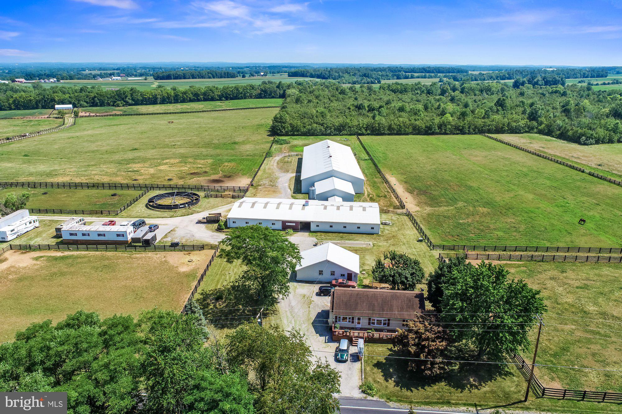 EQUESTRIAN LOVERS dream farm. Nestled in the heart of GETTYSBURG. Welcome home to your 61+ Acre PROFESSIONAL equestrian breeding facility. This quaint rancher style home is the perfect addition to a farm focused property. Living the EQUESTRIAN life and having the potential to operate a professional breeding farm is a once in a life time chance to make your dream a reality.
The property offers a rancher home with three bedrooms, 2 baths, with a walk out basement and deck out front for relaxing after long day. It also has a 3 car detached garage with oversized entrance and lift that stays with the property. Property has active security cameras on site.
The farm features and amenities include: 34 EQUESTRIAN STABLES with some boasting low view doors, monitoring system, and 8 Temporary Stalls. The Stables have been designed to allow the horses to exercise indoor and around the stables and no need to leave the barn.
There is also a 10 TON FEED SILO with an inside dedicated room with grinder.
Every detail is thought out including a 30,000 Gallon underground WATER TANK by the arena. Safety of the farm and horses is the primary focus. The water tank is filled though rain capture with custom gutters on the arena. The attachment for the pump is already in place for the fire department.
The stalls are attached to the ARENA through a walkway. You will never have to take the horses into harsh weather to ride in your large spacious 72 x 200 Arena. This INDOOR RIDING ARENA is large and has airflow for all weather types. BEAUTIFUL to see, and even more exhilarating to own for a Equestrian lover or professional.
The 6 HORSE ROUND exercise pen is fully equipped with electric fencing as well as the entire fenced in area on the farm. SOLAR PANELS are used for charging. Helping to make the electric bill lower and the attention to alternative energy resources.
There are 3 RUN in buildings ALL EQUIPED with FRESH WELL WATER for the Horses, including a pump by the middle building. Wait until you see the perfect little POND for FISHING near many pastures and runs with gates for catching.
Every detail and thought for what makes a farm run at a top level has been implemented here. So many options for this beautiful GETTYSBURG Gem. History, Farm, Business Opportunity, an EQUESTRIAN LOVER MUST!