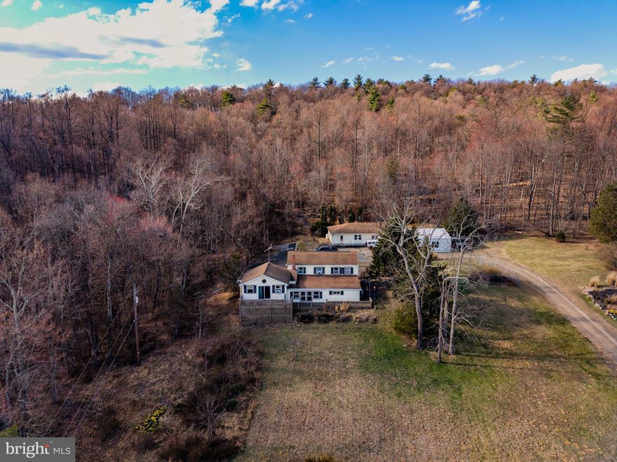 Located in a serene setting, this property offers a perfect blend of tranquility and functionality. The expansive 25 acres provide ample space for outdoor activities, gardening, hunting and enjoying nature. The picturesque pond stocked with koi fish adds a touch of elegance and serenity. Whether you seek a peaceful retreat or a place to create, the heated workshop cater to your needs. The detached garage ensures convenience and ample storage space. With breathtaking views this is a place to make your dream home! There are 20 additional acres available for sale as well. Home being sold as-is.