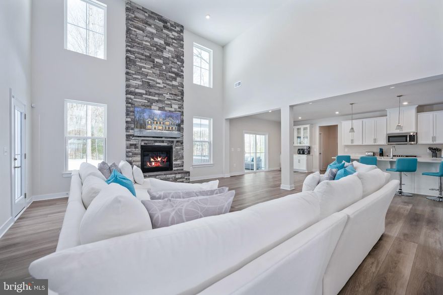 Experience the epitome of luxury living in this stunning traditional-style residence, meticulously crafted in 2024. Spanning an impressive 4,256 square feet, this home offers an unparalleled blend of elegance and modern convenience, set on a sprawling 1.81-acre lot surrounded by serene trees and woods, providing a tranquil retreat from the hustle and bustle of everyday life. Step inside to discover a grand entryway that leads to an expansive open-concept living space, adorned with exquisite ceramic tile and luxury vinyl plank flooring. The gourmet kitchen is a chef's dream, featuring top-of-the-line stainless steel appliances, including a double oven and ENERGY STAR refrigerator, complemented by a spacious butler's pantry. The heart of the home is the inviting living room, where a stunning stone fireplace serves as a focal point, creating a cozy ambiance for relaxation. With five generously sized bedrooms, including an entry-level suite, this residence ensures ample space for both privacy and togetherness. Each of the five full bathrooms is designed with sophistication in mind, featuring luxurious walk-in showers that elevate your daily routine. For those who appreciate the finer things in life, the wet/dry bar offers an ideal setting for entertaining guests alongside the in-home movie theater, while the walk-in closets provide abundant storage for your wardrobe. The home is equipped with modern security features, including a comprehensive security system and smoke detectors, ensuring peace of mind. Outside, the property boasts a side-entry two-car garage with inside access with an added third car front entry garage for all your toys, complemented by an asphalt driveway that enhances the home's curb appeal. The wooded lot allows for a low-maintenance lifestyle, while the surrounding natural beauty invites outdoor activities and relaxation. This residence is not just a home; it's a lifestyle. With energy-efficient features, including OWNED solar panels, you can enjoy sustainable living without compromising on luxury. Embrace the exclusive lifestyle this property offers, where every detail has been thoughtfully designed for comfort and sophistication. Don't miss the opportunity to make this exquisite residence your own.