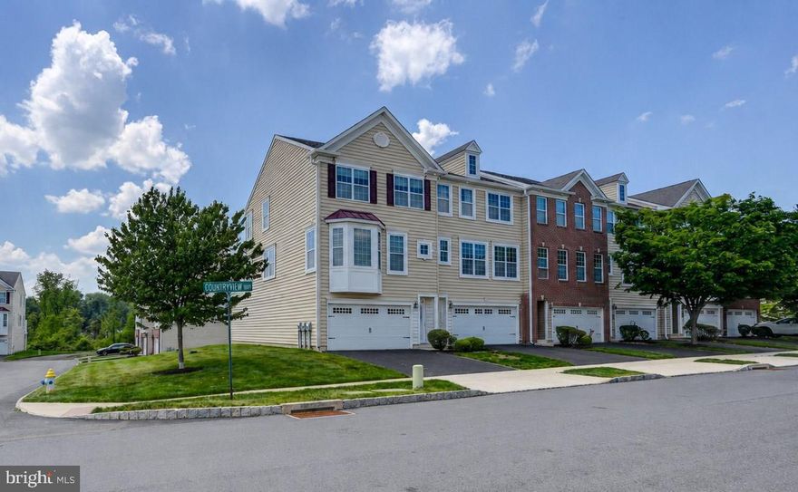 Welcome to 153 Country View Way in The Villages at Country View in Telford — a stunning 3-bedroom, 2.5-bath townhome offering stylish, low-maintenance living in a desirable community setting. Nestled in a serene, established community, this exquisite end-of-row townhouse embodies the perfect blend of luxury and comfort. Built in 2012, this Colonial-style residence boasts a sophisticated design and high-end finishes that create an inviting atmosphere throughout. 
Step inside to discover a spacious, open floor plan that seamlessly connects the living and dining areas, enhanced by warm wood floors throughout and abundant natural light. Imagine entertaining family and friends in this open, flowing space!
The gourmet kitchen is a culinary enthusiast's dream, featuring granite countertops, a generous island, SS appliances and ample table space for casual dining. With built-ins and a pantry, this kitchen is as functional as it is stylish. The adjoining breakfast area is perfect for enjoying morning coffee while overlooking the beautifully landscaped surroundings. The breakfast area opens to a bright and airy sunroom and adjoining upper deck complete with a retractable awning where you can entertain friends and family or enjoy peaceful summer evenings. 
The spacious living room features a gas 3 sided fireplace and a built-in window seat where you can curl up and read a book and enjoy the views of the beautiful community beyond. 
Retreat upstairs to the light-filled primary suite, where a huge walk-in closet and a luxurious en-suite bathroom await. Two additional well-appointed bedrooms provide ample space for guests or a home office, complemented by a full bathroom. 
Downstairs, the fully finished expansive, walk-out 'basement' is designed as a flex space and is perfect for a family room, office, gym, or playroom, along with a large storage closet for added convenience.  This area leads to a 2nd outdoor space, featuring a covered patio with durable Trex flooring. This area is perfect for green thumb enthusiasts to add potted veggies or flowers or you could retreat to this area to unwind after a long day.
Outside, the property and surrounding community is equally impressive. The corner lot adjoins open space, providing a sense of privacy and tranquility. Take a tour of this beautiful community on foot along the mile-long walking trail.  You will stroll by gorgeous mature landscaping open play areas or you can venture to the tot lot and open play field. Parking is a breeze with an attached garage and a private asphalt driveway, accommodating multiple vehicles with ease. Guests can park in the overflow parking spaces located in several areas throughout the community.  Enjoy a low-maintenance lifestyle with the HOA taking care of lawn maintenance, snow removal and trash pickup. 
Conveniently located with easy access to Route 309 and other major transportation, shopping and restaurants, this home is not just a residence; it's a lifestyle choice that combines elegance, comfort, and convenience. Experience the luxury of modern living in a setting that feels like home - it's the best of both worlds!  
** NOTE: (3) Photos (Breakfast Nook, Bedroom 2 and Family Room) are virtually furnished using AI**