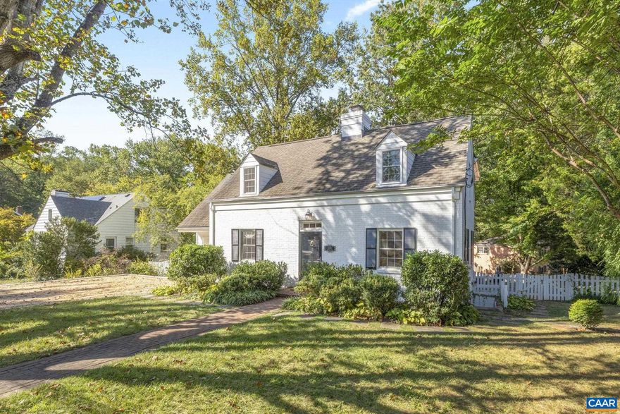 This quintessential Cape Cod on tree-lined Oxford Road combines a house with charm, character, and functionality, with an unbeatable Charlottesville location, a stone?s throw from UVA and Historic Downtown. The main floor offers a layout ideal for both everyday living and entertaining, with a kitchen, dining room, living room, and bonus room, each a distinctive space, flowing together seamlessly. The heart of the home is a beautiful open-concept kitchen with Carrara marble countertops, subway tile backsplash, a farmhouse sink, and stainless-steel appliances. Upstairs are four bedrooms, including a primary suite with tall ceilings, natural light, and a spacious bathroom. Two other bedrooms feature cedar-lined window seats, while another currently serves as a home office. The finished basement (2018) has a family room and private guest suite with exterior access. Off the kitchen are multiple outdoor living spaces, including a screened porch, bluestone patio, large, fenced yard, and play set. Among many recent improvements are the patio, a two-car-wide gravel driveway, gas fireplace, overhead lighting, custom window treatments, and high-end Visual Comfort light fixtures.,Marble Counter,White Cabinets,Fireplace in Living Room