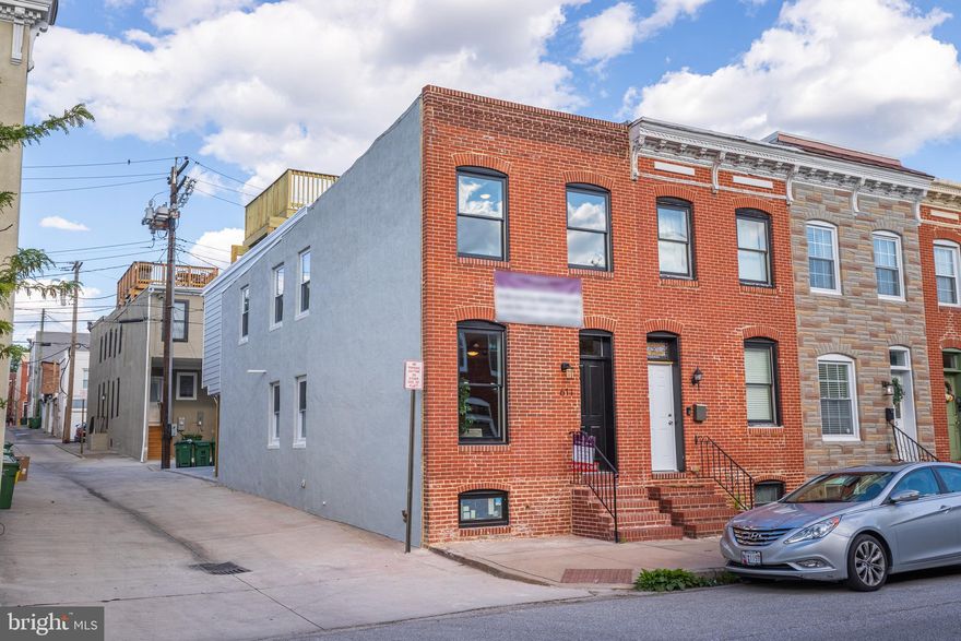 LARGE END OF GROUP CHAP TAX CREDIT RENOVATION W/ 2 CAR PARKING - this 14' wide light filled renovation features an open floor plan with hardwood floors throughout, exposed brick and designer island kitchen with stainless steel appliances, quartz countertops, floating shelves, tile backsplash and under cabinet lighting leading to oversized parking pad.  Upper level offers two large bedrooms, convenient hallway laundry and rear owner suite w/ luxurious connecting bath with double bowl vanity, marble tile accents and modern fixtures.  Access to roof deck from hallway with remarkable water, downtown and park views.  Finished basement with 8' ceilings - chap tax credit pending final approval!