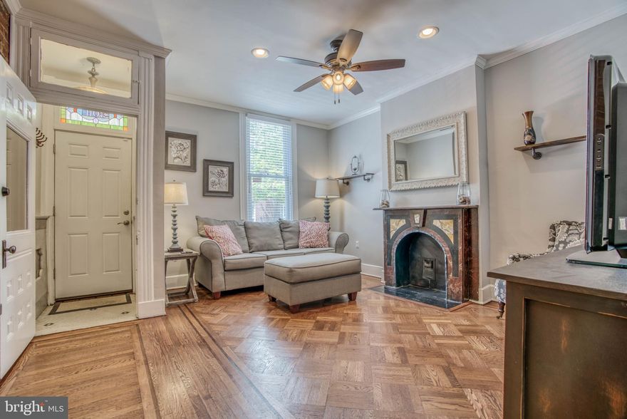 Thoughtfully updated home just off Canton Square. Historic details combine seamlessly with modern updates.  Lovely parquet inlaid floors, original staircase, and stunning scagliola slate mantle ,welcome you into the living room.  Updated kitchen with granite and stainless, main level powder room and laundry.  Easy access PARKING PAD,  3 true bedrooms on upper level along with recently redone bath.   Good height in full basement great for storage, workshop, or finish without the expense of digging.  HVAC and Water Heater approximately 5yrs old.   All a stones throw to all of the great shops and restaurants in Canton.