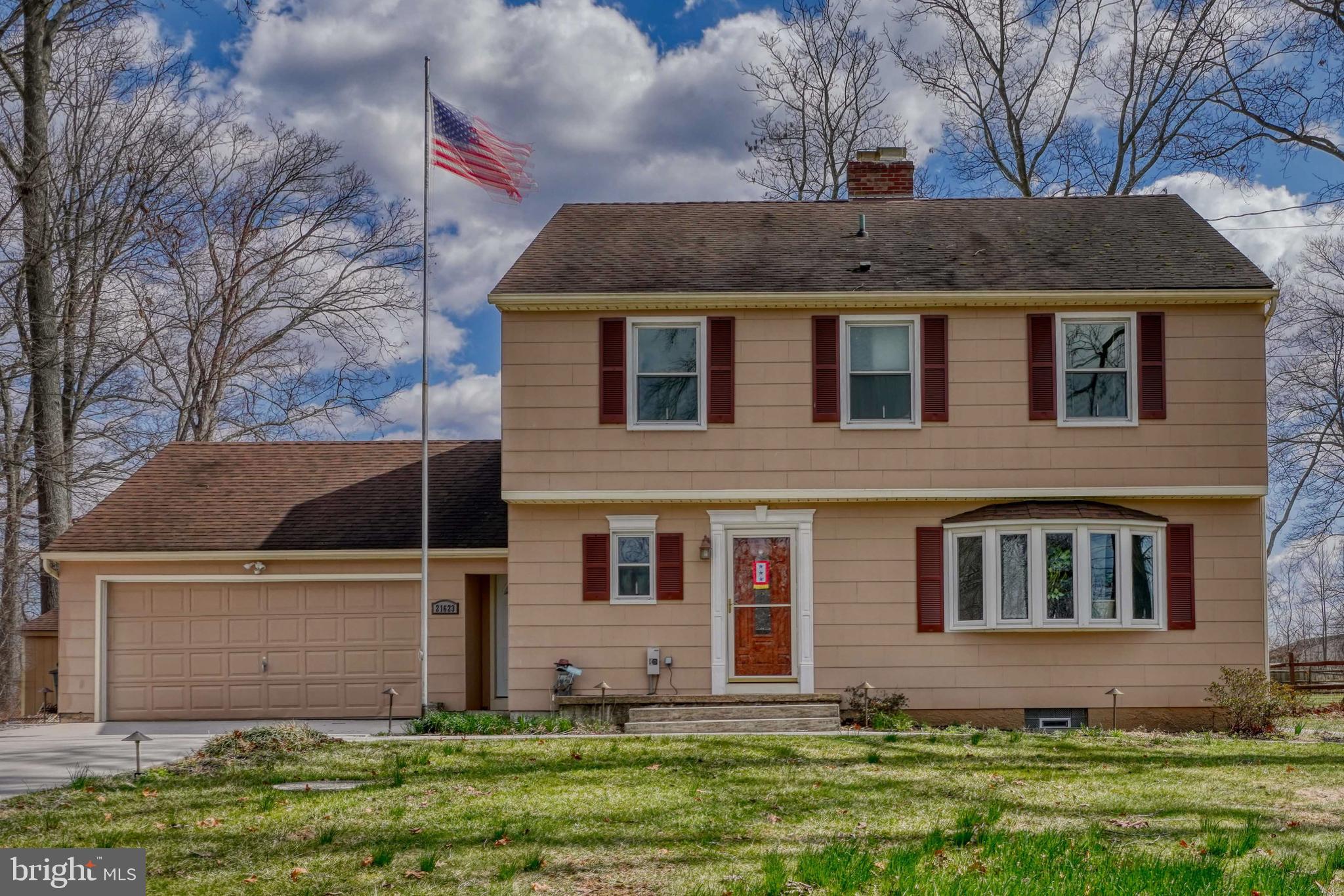 Beautiful Colonial home with adjacent lot included! Main level with family room, living room, kitchen, dining room, and 1/2 bath. Very spacious upper level with 4 bedrooms and 2 baths. Attached two-car garage.
