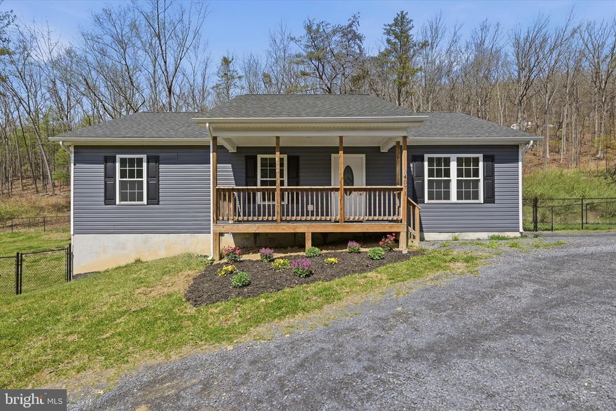 Beautiful setting- Built in 2022, this ranch home offers convenient main-level living and an open floor plan, perfectly designed for everyday comfort. This home features 3 bedrooms and 2 full baths, including a spacious primary suite with a private full bath. The stylish kitchen showcases beautiful gray cabinetry, a large center island, granite countertops, stainless steel appliances, and durable LVP flooring throughout the main living areas.
Enjoy outdoor living on the covered front porch or rear deck overlooking the fenced yard—ideal for relaxing, entertaining, or pets. The full unfinished walkout basement provides excellent potential for additional living space, storage, or future customization. Located in a quiet neighborhood on the outskirts of the Town of New Market, this home offers scenic mountain views while being just minutes from locally owned shops, restaurants, and the farmers' market. Outdoor enthusiasts will appreciate the proximity to the George Washington National Forest and the Shenandoah River, offering endless opportunities for hiking, fishing, and recreation. All sizes are approximate.