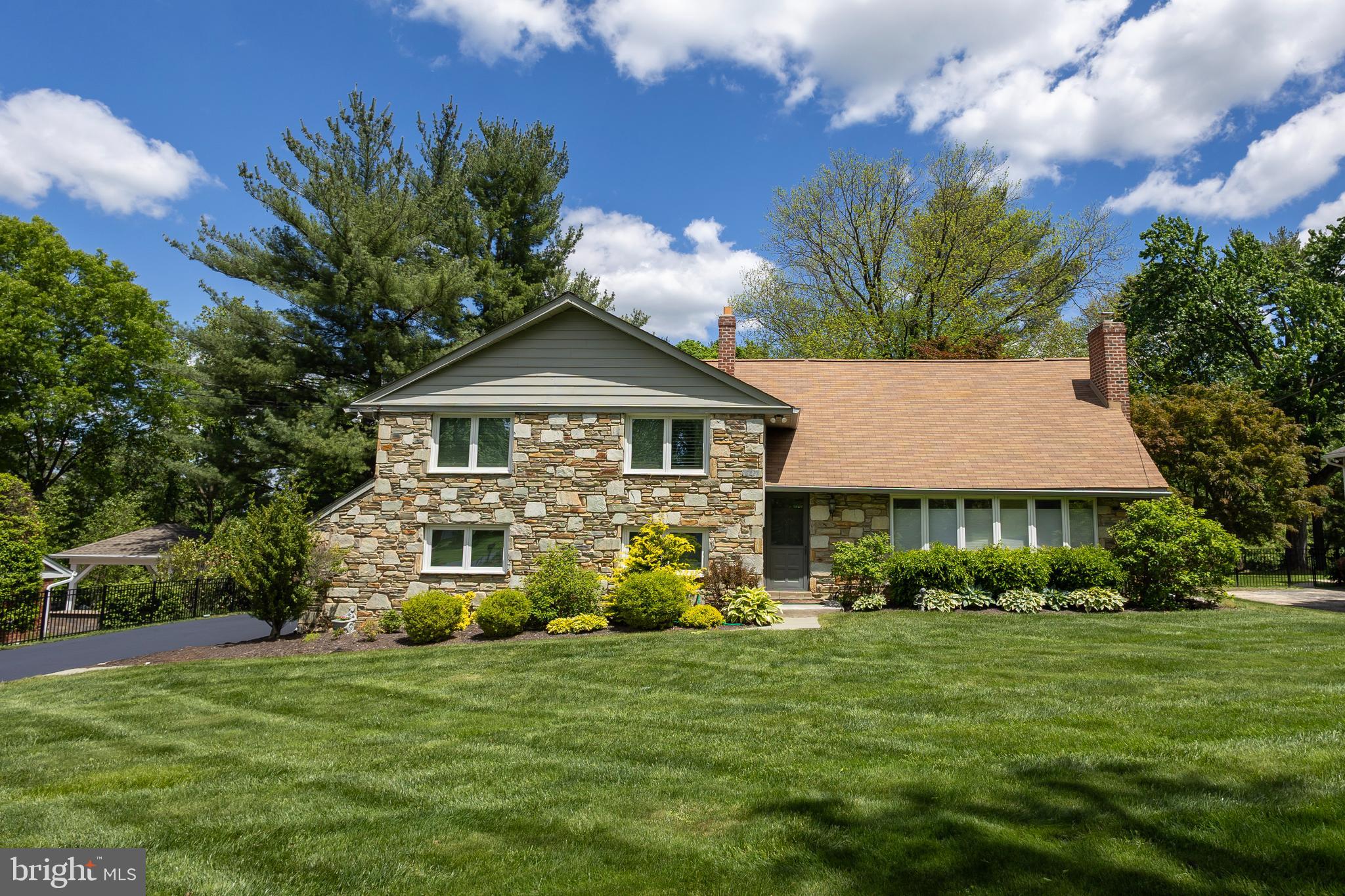 Welcome to this beautifully maintained 4-bedroom, 3 full bath split-level home nestled on a spacious and manicured 0.68-acre lot in the heart of Penn Valley. This bright and inviting residence offers a perfect blend of classic charm and modern updates, ideal for comfortable family living and entertaining.
The formal living room is bathed in natural sunlight and features gleaming hardwood floors and a stunning wood-burning stone fireplace, creating a warm and welcoming atmosphere. The hardwood floors continue into the formal dining room, perfect for gatherings and special occasions. The updated eat-in kitchen boasts ceramic tile floors, granite countertops, stainless steel appliances, and a view overlooking the expansive, level, fenced-in backyard—an ideal space for outdoor fun and relaxation. Step down into the cozy family room with a second fireplace, ceramic floors, access to the backyard, a newly renovated full bathroom, and a convenient laundry room. A few steps further lead to a versatile finished basement offering additional living space—perfect for a playroom, home gym, office, or media room. Upstairs, the primary suite features separate closets and a luxurious new ensuite bathroom with a glass-enclosed shower. This level has three additional spacious bedrooms and another beautifully updated full hall bathroom. Other features include a 2 car garage and new heating and air conditioning unit. Located in the award-winning Lower Merion School District, this home offers an easy commute to Center City with convenient access to major roadways. Close to top-rated schools, parks, and places of worship, this home truly has it all. Don’t miss your opportunity to own this wonderful home in a prime Penn Valley location!