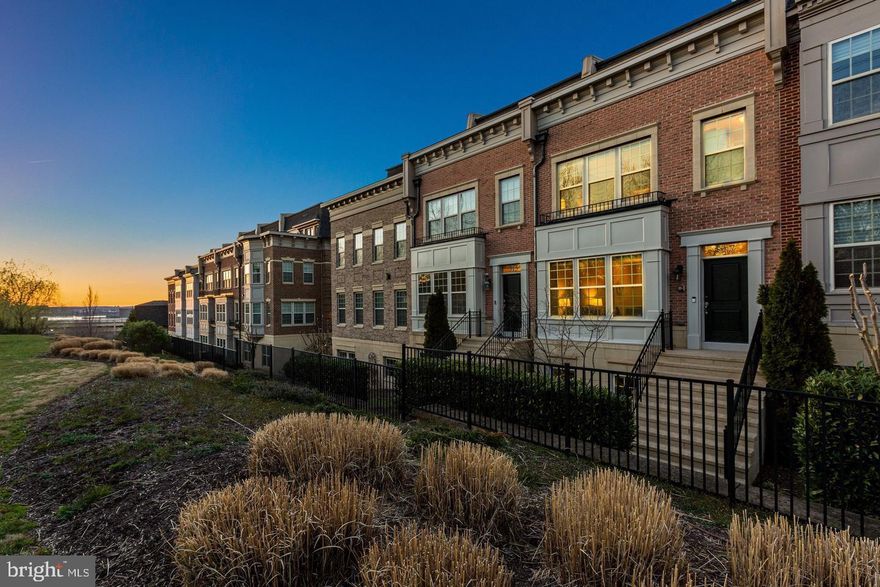 Welcome to 517 Overlook Park — a luxury 4-level townhome in National Harbor where the rooftop views truly steal the show. With 3 bedrooms, 5 bathrooms, a 2-car garage, and 3,300+ square feet, this freshly painted, move-in-ready home is designed for elevated everyday living and unforgettable entertaining. You’ll also appreciate the recent upgrades, including all newer kitchen appliances and blinds throughout.
The main level features an open, airy layout with the living and dining spaces facing a peaceful tree line, creating a calm backdrop while still feeling bright and connected. The gourmet kitchen is the heart of the home, complete with granite countertops, a large center island, plenty of windows for natural light, and a comfortable dining area. With the brand-new appliances and a double oven, it’s set up perfectly for everything from quick weeknight meals to hosting holidays.
When it’s time to unwind, the owner’s suite feels like a private retreat with a large customized walk-in closet and a spa-like ensuite featuring double sinks, a soaking tub, and a separate shower. A second suite is located on the third level, offering great privacy for guests or flexible living. The fourth level opens up to a loft-style entertaining space with an impressive wet bar—the perfect spot to serve drinks before stepping outside to the rooftop terrace to take in those breathtaking river views and sunsets. The third suite is also on the fourth level and can easily function as an office, guest suite, or private lounge space. All suites include customized closets, and the recreation room provides even more flexibility—ideal for a home gym, movie room, or play space.
Located in the sought-after Potomac Overlook gated community, you’re perched above National Harbor and just minutes from its vibrant waterfront lifestyle—restaurants, coffee shops, shopping, the marina, and attractions like the Capital Ferris Wheel, plus destinations such as Gaylord National and MGM. National Harbor is also conveniently close to Washington, DC and Virginia, with easy access to nearby military installations including Bolling AFB, Andrews AFB, the Pentagon, Ft. Belvoir, and the Navy Yard. Reagan National Airport is approximately 8 miles away, and Crystal City is nearby as well.
If you’ve been looking for luxury living with space, style, and a rooftop view that feels like a daily getaway, 517 Overlook Park is a must-see. Schedule your private tour today!