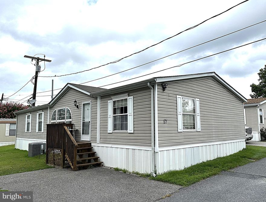 Beautiful Double Wide at a Great Location in Elkridge! This Home Features a Big Kitchen with Updated Cabinets, Granite Counters, New Luxury Vinyl Plank Flooring, Kitchen Island, New Oven/Range, New Dishwasher, Bonus Room off of the Kitchen that can be used as a Den or Office and New Washer and Dryer. There is a Large Living Room with Gleaming Hardwood Floors and Separate Formal Dining Room.  Big Primary Bedroom with Huge Walk-in Closet, Hardwood Flooring, and a Superbath with Custom Ceramic Tile, Jacuzzi Tub, Separate Double Shower and His and Her Vanity Sinks. The Nice Sized 2nd and 3rd Bedrooms also have Hardwood Floors and All Windows have Mini Blinds. Outside Features are New AC Unit and the Roof is just 5 Years Old, The Home is Close to Schools, Parks, Shopping and Restaurants. Minutes to Rt 100, 95 and a Short Drive to Downtown Baltimore. Own this Great Home for less than the Cost to Rent!