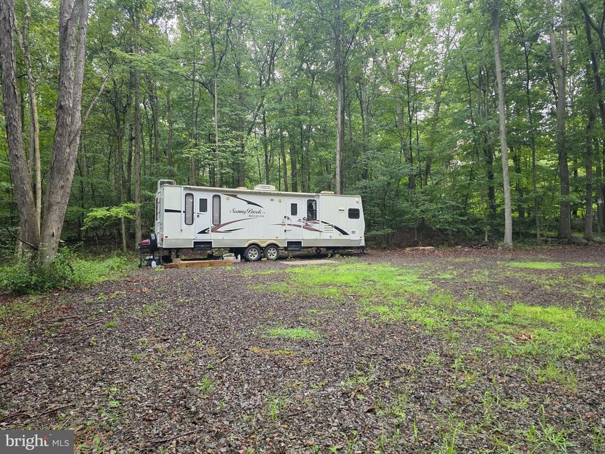 Discover your own slice of West Virginia paradise with this picturesque 5-acre wooded property, complete with approved electric service already in place. Located on a well-maintained state road, this lot offers the perfect setting for a permanent residence or a peaceful weekend escape.
Enjoy access to the stunning 900+ acre Jennings Randolph Lake, just 3 miles from the property, where you'll find a state park boat ramp and ample parking. The lake is a haven for fishing, boating, and watersports. The nearby State Park also features a sandy beach, picnic areas, camping facilities, and a 3-D archery range.
Outdoor enthusiasts will love the proximity to over 6,200 acres of public hunting land in the Mountaineer Wildlife Management Area. The surrounding Mineral County area also offers extensive ATV trails for year-round adventure.
Currently used as a private camping retreat, this property features a level layout perfect for building. It's truly a hunter's paradise, with deer, turkey, squirrel, and even the occasional bear frequenting the area. Peaceful, quiet, and tucked away-this land embodies solitude and a natural beauty.
Don't miss this rare opportunity to own a piece of West Virginia's best-kept secret.
Bonus: A beautiful 31-foot Winnebago Sunnybrook Brookside 302FKS travel trailer is also conveys with the property!