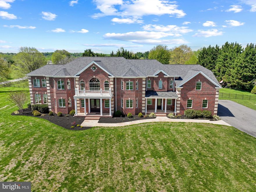 Welcome to 1820 Woodstock Road, where grandeur meets everyday livability. A masterpiece of scale and craftsmanship, this exceptional estate custom-built in 2020 is where over 13,000 square feet of exquisitely finished living space with resort-style amenities come together in a truly impressive luxury offering. The distinguished property is set on three acres, approached by a long driveway and complemented by professionally-designed landscaping and picturesque, scenic views. This home embodies luxury living, elevated in every detail. 

The interior presents 11,380 finished square feet across three levels, with luxe finishes, expansive spaces, and refined craftsmanship throughout. Inside, a breathtaking two-story foyer with marble floors and dual staircases sets an impressive tone. Rich hardwoods, sundrenching windows, intricate millwork, and the finest of finishes flow throughout the elegant interior. The formal living room with French doors and bay windows seamlessly leads to a stunning conservatory with coffered ceilings and panoramic windows. Opposite, the refined dining room boasts bay windows, wainscoting, and a tray ceiling with chandelier, while a private study with a walk-in closet and dual-entry access to a full bathroom adds both flexibility and functionality as a potential main level in-law suite.

The soaring two-story great room has columns, exposed beams, a floor-to-ceiling stone fireplace, and a wall of windows flooding the space with natural light. The chic sitting room has French doors that lead to the patio and pool area, accompanied by the nearby butler’s pantry with a bar area, and the stylish spa-inspired powder room. These spaces are wonderfully curated for effortless and enjoyable hosting and gathering. The incredible kitchen is equipped for everyday living and elevated entertaining with Sub-Zero® and Wolf® appliances, a pot filler, built-in hood, island with breakfast bar, walk-in pantry, abundant ceiling-height cabinetry with lighting, gorgeous counters with plenty of prep space, and designer pendant lighting. A breakfast bar connects the bright breakfast room overlooking the pool and yard. A well-appointed mudroom offers built-in cubby storage and convenient exterior access. 

Upstairs, the opulent primary suite is a true retreat complete with a private sitting room, gas fireplace, built-ins, beverage bar, private balcony, three walk-in closets, and spa-inspired bath with a soaking tub, dual vanities, oversized shower, and two water closets. A connected private bonus room is an ideal space for a nursery, dressing room, or office. Three additional bedrooms—each with an ensuite bath and a walk-in closet—along with a laundry room, complete the upper level.

The lower level unfolds as a dynamic, amenity-rich living space with LVT flooring throughout, a huge rec room with a full bar, a true home theater, game room, fitness or bonus room, bedroom with walk-in closet and dual-access full bath, versatile bonus space, and ample unfinished storage. Outdoors is equally captivating—boasting an expansive patio with a fully-equipped outdoor kitchen centered around a heated saltwater Roman pool. The surrounding patio extends to a gazebo ideal for al fresco dining, complemented by a gas fire pit and set within a sprawling, beautifully-landscaped, tree-lined backyard with a resort-style setting. Enjoy garage parking for 6 cars in an attached 4-car garage and detached 2-car garage.

This desired address in Howard County’s sought-after Marriotts Ridge School District offers a rare balance of refined countryside tranquility and seamless access to major commuter routes, top-ranked schools, and cultural and business hubs of Baltimore and Washington, D.C. Surrounded by rolling landscapes and preserved natural beauty, it delivers an elevated lifestyle defined by convenience, privacy, and prestige. Architectural Excellence, Thoughtfully Executed...rarely will you see an opportunity or property like this.