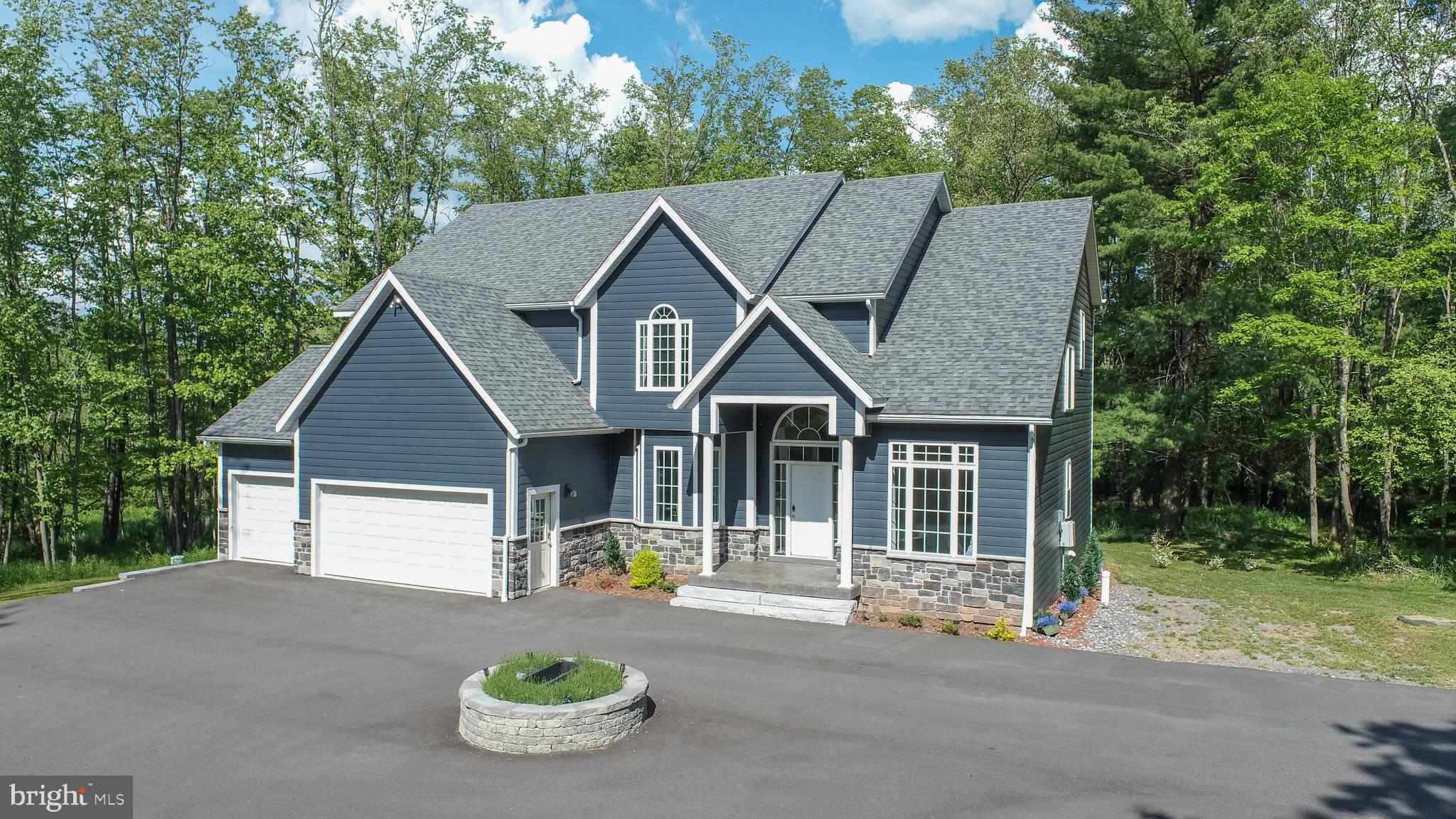 Gorgeous 7 bedroom home with dock slip! This newer construction home sits on a quiet corner of Deep Creek Lake with 200 feet of lake frontage. Located in the beautiful and quiet Heron Cove community and comes with two community lake access points, one with a sandy beach area, tennis courts, and walking trails. The level lot is surrounded by trees and designed for privacy and outdoor enjoyment, with a deck, stamped concrete patio, swim-spa, and playground. You are also a very easy walk down the lane to your boat slip in a no-wake cove. Inside, the large kitchen is the perfect spot for cooking family meals to be enjoyed in the breakfast nook or separate dining room. The great room boasts a light filled living area with gas fireplace accessible to the entire floor. You’ll also find a sunroom for morning or afternoon relaxation, laundry and an attached two car garage for convenience. Upstairs includes the primary suite with large walk-in shower and jetted tub in addition are two other ensuite bedrooms for additional privacy and comfort. The downstairs boasts additional bedrooms, a family room, bathroom, and a gym complete with sauna. This is the ultimate lake vacation home. Make it yours today!