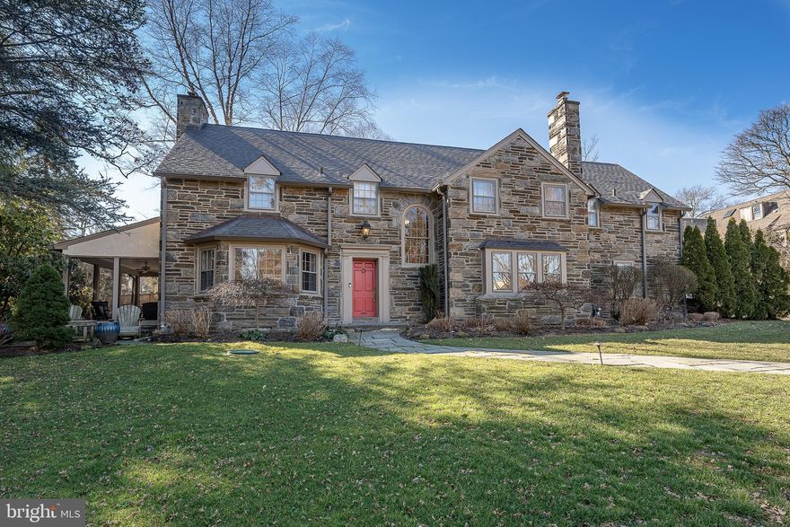 This 1940 stone colonial home in Wynnewood turns on the charm as soon as you step in from the welcome mat.  The spacious expanded kitchen with breakfast area and built in desk maximizes workspace and flexibility. A classic island with marvelous counter space and major appliances compliment plenty of white cabinetry. The living room features a cozy fireplace to snuggle by on the cold winter evenings and opens up to a wide stone porch perfect for your morning coffee or reading a great book.  
For relaxation and recharging, the primary suite with an updated bathroom is where to be after a long day. In addition to the convenience of the private bathroom with a walk in shower, you will find plenty of closet space and nice touches. The other 4 bedrooms also with plenty of closet space, are also located on this floor for enhanced privacy. Also on the 2nd  floor are steps leading to an amazing full size attic with an abundance of unending storage. 
The lower level is fully finished and includes a temperature controlled wine room, laundry room, recreation room, half bath and even an entrance to the garage.  
The large back terrace provides plenty of opportunity to enjoy sunset dinners or a starry night cap.  
A driveway with ample accommodation for visiting vehicles leads to an attached garage that is available for its original purpose or for use as additional flex space. 
All tucked away on a pleasant tree lined street a mere stroll from the allurements of the Main Line.  

Some Photographs are photo shopped