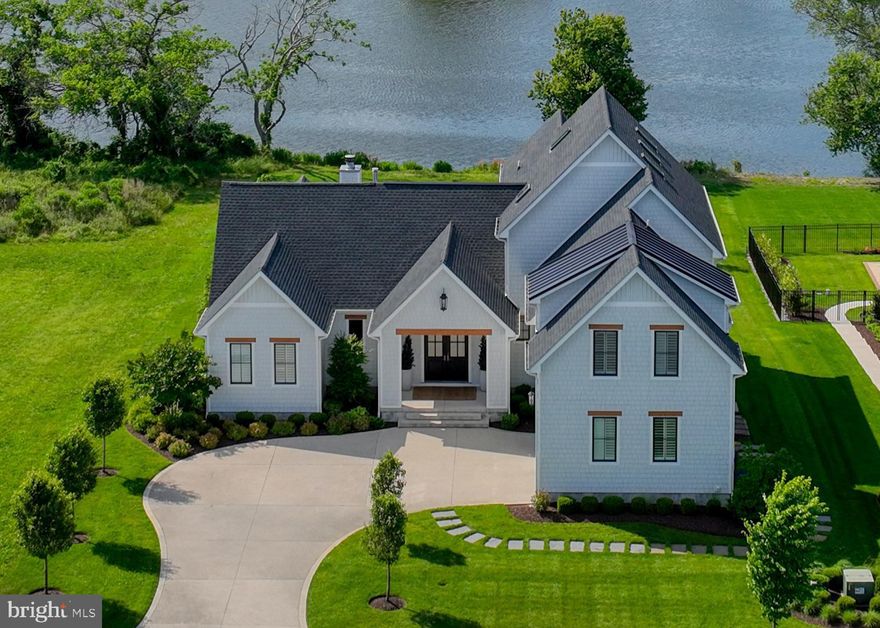 EXPERIENCE THE EPITOME OF LUXURY LIVING IN SHOWFIELD…Step into a realm of sophistication and elegance that rivals the pages of Architectural Digest.  Being sold completely furnished, indulge your family & friends with a spacious seamless entertainment flow from room to room with the perfect mix of coastal modern design - accented with gorgeous hardwood flooring and built-in surround system throughout this unparalleled waterfront home. From the inviting interior, step outside onto an expansive patio entertainment space that provides access to the large backyard which leads directly to White’s Pond, where serene waters with local wildlife and awe-worthy sunsets await.  Or, slide open the expansive NanaWall glass doors on the upper porch off the main living space to retreat to seamless indoor /outdoor living with a retractable full screen and to enjoy the inviting wood-burning fireplace and outdoor kitchen area. The elegance of your interior space starts with an expansive great room, with its vaulted ceiling and gas fireplace, flowing into the gourmet kitchen at the heart of the home with high-end appliances, natural gas cooking, quartz countertops & walk-through butler’s pantry.  From the 1st level owner’s suite to the 3 additional 2nd level bedrooms, you will be surrounded by the sophistication of custom tile work in all the baths, as well as custom California Closets for each bedroom. Need two office spaces? A dedicated office is located on the first floor and another in the 3rd Floor loft. Every element of this property reflects quality, craftsmanship and sophistication – an enviable architectural and design masterpiece where luxury meets lifestyle.  All of this and only doors away from the Showfield Club House & Pool, a walk or short bike ride to downtown Lewes and the Beach.