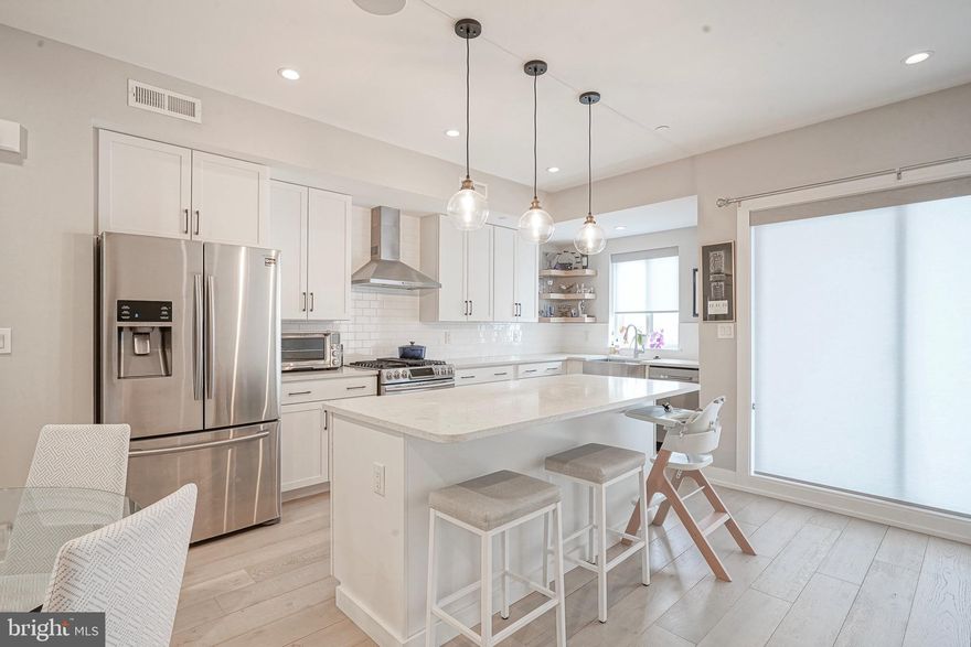 ** Ask for link to VIDEO TOUR ** Location. Lifestyle. Luxury. Perfectly positioned right by Fishtown, this stunning contemporary townhome offers the ultimate blend of urban sophistication and convenience. Nestled within a rare and exclusive, gated community called Blair Gardens. This exquisite residence offers a tax abatement, newer roof with 30 year warranty, largest roof deck in the development, garage parking (EV charging available), two outdoor spaces, and access to a well designed common area. Experience unparalleled walkability to Fishtown’s vibrant nightlife, acclaimed restaurants, cozy cafés, lush parks, and eclectic boutiques. Commuting is effortless with quick access to I-95 North & South, New Jersey bridges, Philadelphia International Airport, and the Market–Frankford Blue Line connecting you to Old City, Center City, University City, and beyond. This home is equipped with hard wired CAT6 for internet, security system with cameras (interior and exterior), integrated home speaker system on multiple levels, newer roof with 30 year warranty, etc. Sunlight floods the interior through oversized windows, accentuating the 9-foot ceilings, rich hardwood flooring, and custom designer finishes throughout. The entry level features a versatile bedroom or home office, a stylish full bath, and convenient garage access. The oversized garage offers sizable storage space. A finished lower level features home theater, with incredible surround sound. This additional space ideal for a media room, gym, or play area. Upstairs, the open-concept main living level is an entertainer’s dream. The chef’s kitchen is appointed with an island, subway tile backsplash, generous storage space and premium appliances. The sliding glass doors invite desirable fresh air into your living space. Step onto your private deck for morning coffee, weekend grilling, or intimate outdoor dining. The living room centers around a striking stone-accented gas fireplace, creating the perfect balance of warmth and style. Retreat to your primary suite, a serene sanctuary boasting oversized windows, custom built-ins for storage and a beautiful en-suite bath. A convenient hallway laundry area and a guest suite with a private bath complete the upper level. Entertain effortlessly on your rooftop deck, where city skyline views set the backdrop for evening cocktails or weekend gatherings. The spacious layout accommodates both lounging and dining with ease. Residents also enjoy access to the landscaped outdoor common area, ideal for casual get-togethers and friendly neighborhood connections. Do not miss out on this rare opportunity.