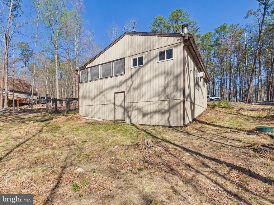 Affordable, move-in ready, and tucked away in The Woods subdivision—this charming chalet is the opportunity you’ve been waiting for! Set on a generous .91-acre lot, this 2-bedroom, 1 full bath home offers the perfect blend of cozy character and thoughtful updates.

Step inside to find durable LVP flooring throughout and a beautifully remodeled bathroom, giving the home a fresh, modern feel. The inviting living area is anchored by a wood-burning fireplace—perfect for relaxing evenings or weekend getaways. A rear laundry room addition (completed in 2017) adds convenience and functionality.

Major updates have already been taken care of, including an architectural shingled roof (2018), vertical vinyl siding (2020), upgraded 6” gutters, updates underneath the home with encapsulation and added storage areas and a (2024) mini-split 3-head system for efficient, year-round comfort.

Enjoy the peaceful surroundings from the enclosed/screened porch—ideal for morning coffee or unwinding after a long day. Whether you’re looking for a full-time residence, weekend retreat, or investment property, this affordable chalet checks all the boxes.

Don’t miss your chance to own in The Woods—schedule your showing today! This property is a member of the recreational center that The Woods community offers including community pools.
