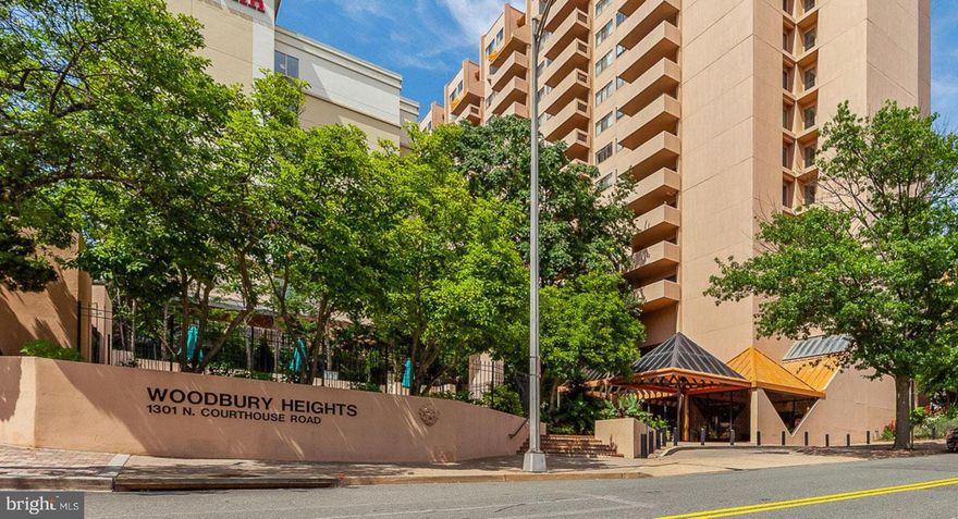 Incomparable and uninterrupted views of the monuments/Potomac River from this 16th floor 2 Br/2 Ba light-drenched + freshly painted 1,143 sq. ft. condo in the heart of Courthouse. Parking is a cinch with 2 oversized and conveniently located garage parking spaces*.  Whether from your expansive East-facing balcony or bedroom, you’ll be awestruck by the straight shot views of the Washington Monument/Jefferson Memorial. The open living/dining/kitchen allows for great entertainment and an easy flow. Kitchen remodeled in 2022 features white cabinets, subway tile, SS appliances and quartz counters w/a pass-through breakfast bar.  The two spacious bedrooms bookend the living space, allowing for private sleeping areas, each with two closets.  Primary en-suite bathroom includes a double granite-topped vanity as well as make-up area + spa-like shower.  Custom Douglas blackout shades in bedrooms w/motorized shade in primary BR .Brazilian cherry wood-floors in living areas w/plush carpet in both bedrooms. New stacked/separate LG washer/dryer (2022).  Large storage unit conveys w/unit.
Full-service and well-managed Woodbury Heights building offers an outdoor pool, fitness center, concierge (7am-11pm, 7 days a week), and on-site management. The condo fee covers these amenities, parking, management, water + hot water. Pet-friendly building (2 pets max; no weight limit). A mere two blocks from the Courthouse Metro, AMC movie theater and countless restaurants. Enjoy the weekend Farmer’s market or walk to Whole Foods. Easy access to Rte-50 into DC or to Rte-110 to Amazon HQ2.  This is convenient urban living with the cherry on top – the million dollar view! *Garage improvement project to be completed 9/25; two-garage parking spaces provided across street pending completion.