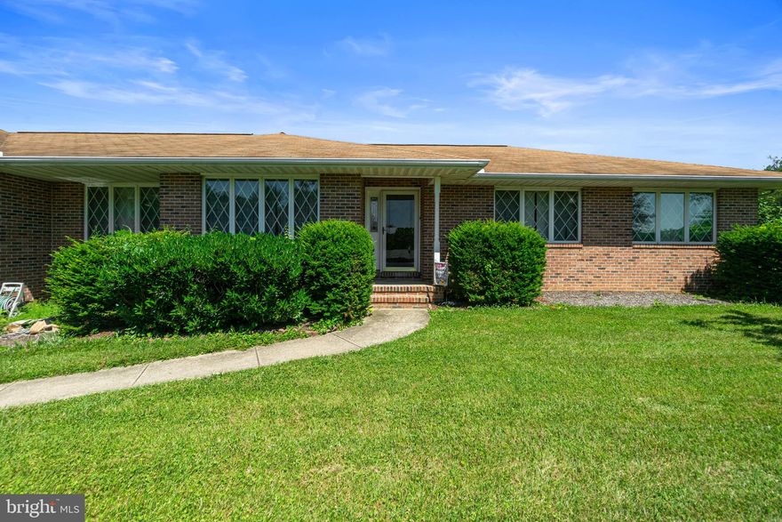 Large  Brick and Vinyl Rancher on 1.13 Acres with a 2 car garage.   Freshly Painted   Over 1800 sq feet and  Custom built by Robin Ford .  Enter the home into the Foyer from the covered entry.  Inside you will find the spacious formal Living Room and separate Dining Room.  The 18X13 Family Room features a large cathedral ceiling, a stone propane fireplace, ceiling fan and Sliding Glass Door to the large patio and deck.   The Eat In Kitchen has  a island and a skylight.  The Kitchen and Family Room are just what you are looking for, completely open.   Off the kitchen you will find the Laundry Room and lots of shelves for storage.  Three very large Bedrooms and two full bathrooms complete the main level.   The basement is unfinished with a outside entrance.   Warm Oil heat and Propane fireplace, water heater and dryer.  You will enjoy the beautiful view and sunsets from the patio and deck.