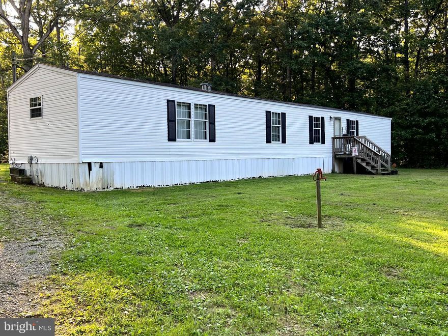 **Price Improvement**  Discover the perfect blend of comfort and tranquility with this well-maintained 2001 mobile home situated on 3.65 acres in Louisa County, just a short drive from Gordonsville, VA. This delightful property offers ample space, modern conveniences, and a peaceful rural setting.
Inside, the home features three bedrooms and two bathrooms. The living room provides a welcoming area for relaxation and entertaining.  The master suite includes a private en-suite bathroom, adding a touch of comfort and privacy. Two additional bedrooms are perfect for family or guests.
The exterior of the property includes a 3.65-acre lot of open, usable land. A small paddock is ideal for horses or small livestock, enhancing the country lifestyle. The yard offers plenty of space for gardening or outdoor activities, and the high-speed fiber internet ensures you stay connected with ease.
Located in a serene rural setting, this home provides the quiet of country living while still being conveniently close to the amenities in Gordonsville. You will find local shops, stores and dining options just a short drive away.