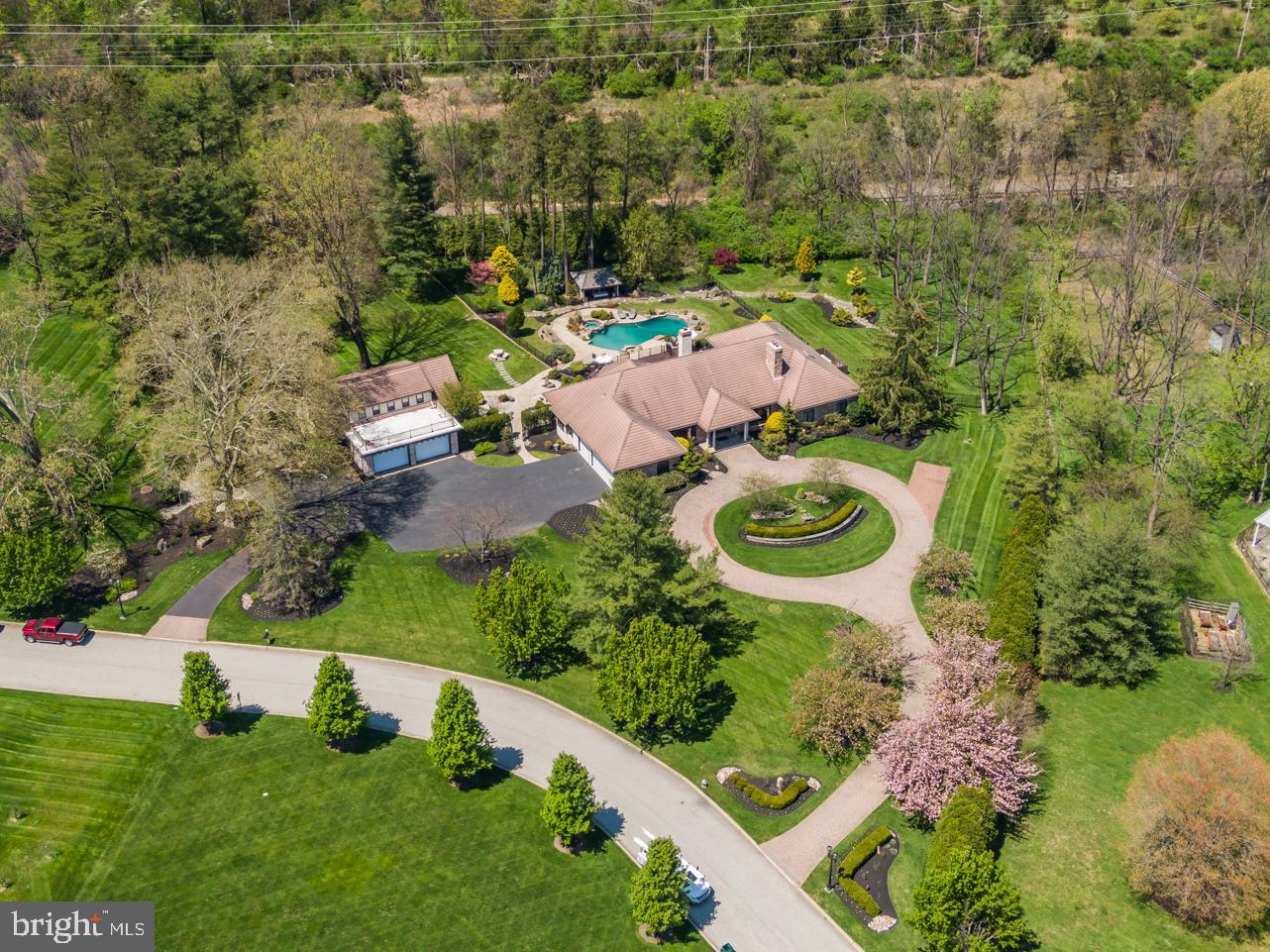 Fantastic Custom Estate In Prestigious Country Club Estates on 2.4 Acres of Privacy with Garage Space for 5+ Cars; Beautiful BackYard with Inground Sylvan Pool and Spa, Pool Deck, and a Wrap Around Deck Across the Entire Back of the Home with a Swim Spa; Country Club Estates is a Small Luxury Home Development with Just 31 Homes, (See Virtual Neighborhood Tour, Click On Camera Button) Located Minutes From Major Highways, Whole Foods, Starbucks and Great Restaurants! The Estate Includes a Luxury Custom Sprawling Ranch Home That is Easy to Maintain and Ready to Move In; Also There is a Beautiful 1912 Vintage 2-Story Carriage House On The Property, Great For Family Visiting, Great For Guest Retreat or InLaw Home/Suite; Lastly, There are 2 Driveways For Plenty of Off Street Parking: a Block Circular Driveway to the Front Door, and The Another Driveway That Leads to a Large Parking Pad Where You Will Have Access to Both the House and Carriage Garages! The Property is Professionally Landscaped with Beautiful Foliage; As Spring Arrives the Entire Street is Lined With Blooming Cherry Blossom Trees, See the Video; Total Above Ground Square Footage in MLS of 6,397 Includes the 4,397 Square Feet of the Home and the Approximately 2,000 Square Feet of the Carriage House; This Amazing Estate Has Been Meticulously Maintained and Has Many Updates; The Home Has 4 Large Bedrooms, An Office Which Could Be the 5th Bedroom, 4.1 Baths and a Large Laundry Room As Well As Upgraded Lighting From Restoration Hardware; Other Features Include New Hardwood Floors in Hall, Living and Dining Rooms, 2 Brand New Baths, New Plush Carpets in Bedrooms and New Molding and Wainscoting Throughout; Center Hall Foyer with Marble Floors; Living Room with Fireplace and Large Bay Window; Dining Room is Oversized with a Large Bay Picture Window; Great room with Vaulted 16’ Ceilings and Floor-to-Ceiling Stone Wall Fireplace And Windows; Large Gourmet Kitchen with Quartz Countertops, Tons of Cabinets, Large Island with Sink, Breakfast Bar, Tons of Floor to Ceiling Windows, a 3 Year Old Stainless Steel Refrigerator and State-of-the Art Appliances; Impressive Views From Kitchen and Great Room of the Private Yard and Pool Area; The Stunning Wainscoted Hallway Leads to the Expansive Owner’s Suite with French Doors Leading to the Deck; Master Bedroom Has a Huge His/Her Walkin Closet and a Large Private Master Bath with Marble Floors, Double Sink Vanity, Jacuzzi and an Oversized Walk In Clear Glass Shower; Second and Third Bedrooms Have Their Own Ensuite Bathrooms, That Were Completely Updated and Have Heated Floors; The Fourth Bedroom Has a Completely Updated Full Bath Right Outside the Door; Office is a Nice Size and Could Be Another Bedroom; The Laundry Room is on the First Floor with Laundry Sink and a W/D That Are Only 2 Years Old; Lastly There is a 7 Year Old Heater/Air Conditioner; The 4000+ Square Foot Basement is Unfinished and Spans the Entire Length of the House; The Large Amazing 2 Story Vintage 1912 Carriage House\In-Law Home Has Tons of Character with an Oversized 2+ Car Garage, 2 Entrances, 4 Bedrooms, an Office, a Completely Updated Full Bath, and a Half Bath Off the Kitchen, Refinished Hardwood Floors, a 5 Year Old Heater\AC Unit and a Basement with Bilco Doors; Other Great Features Include a House Generator, Security System, Custom Blinds Throughout, Lawn Sprinklers and a Sturdy High End Moniar Tile Roof That is Indestructible; The Original Owner Owned a High End Roofing Company and Installed the Best Roof! Community Sewer System For House, Carriage Home is on Septic; Public Water For Both House and Carriage House; Well is Available For Watering Lawn; This Home Will Not Last!!! Please note that the Crack In the Bathroom Mirror is going to be Repaired before Settlement. Certified Pre-Owned Home Has Been Pre-Inspected, Report Available in MLS Downloads, See What Repairs Have Been Made!